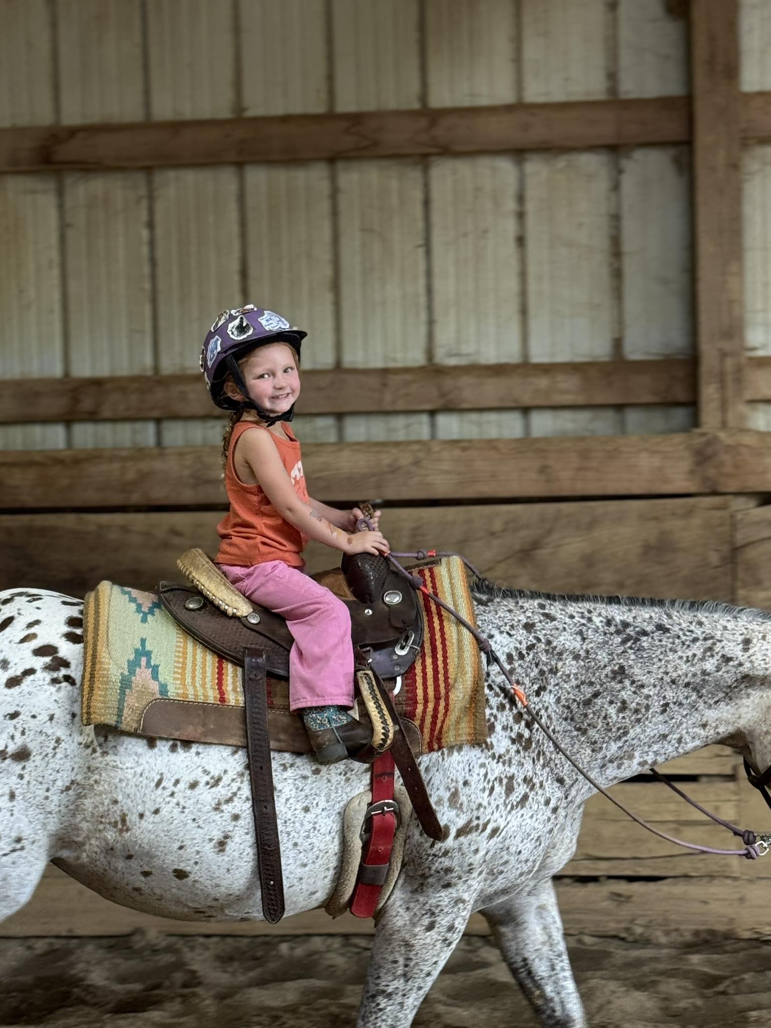 Young Pee Wee rider smiling on appaloosa horse