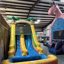 Tropical slide and unicorn bounce house
