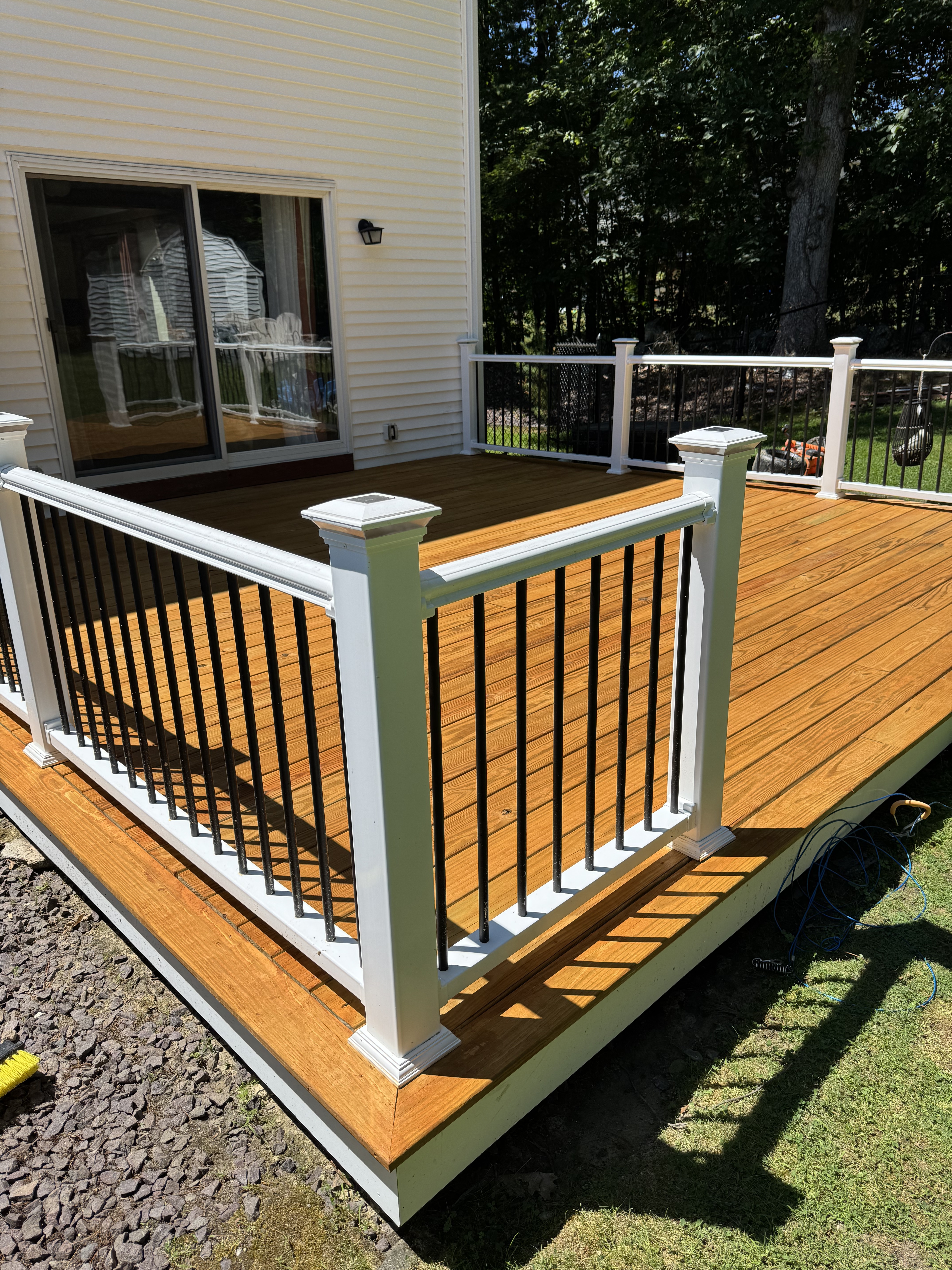 Custom deck with white railings and solar post caps