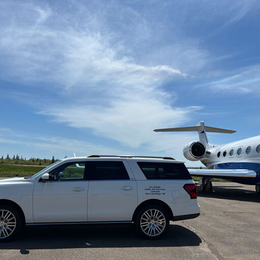 Ford Expedition Max beside a private jet at Port Hawkesbury Airport