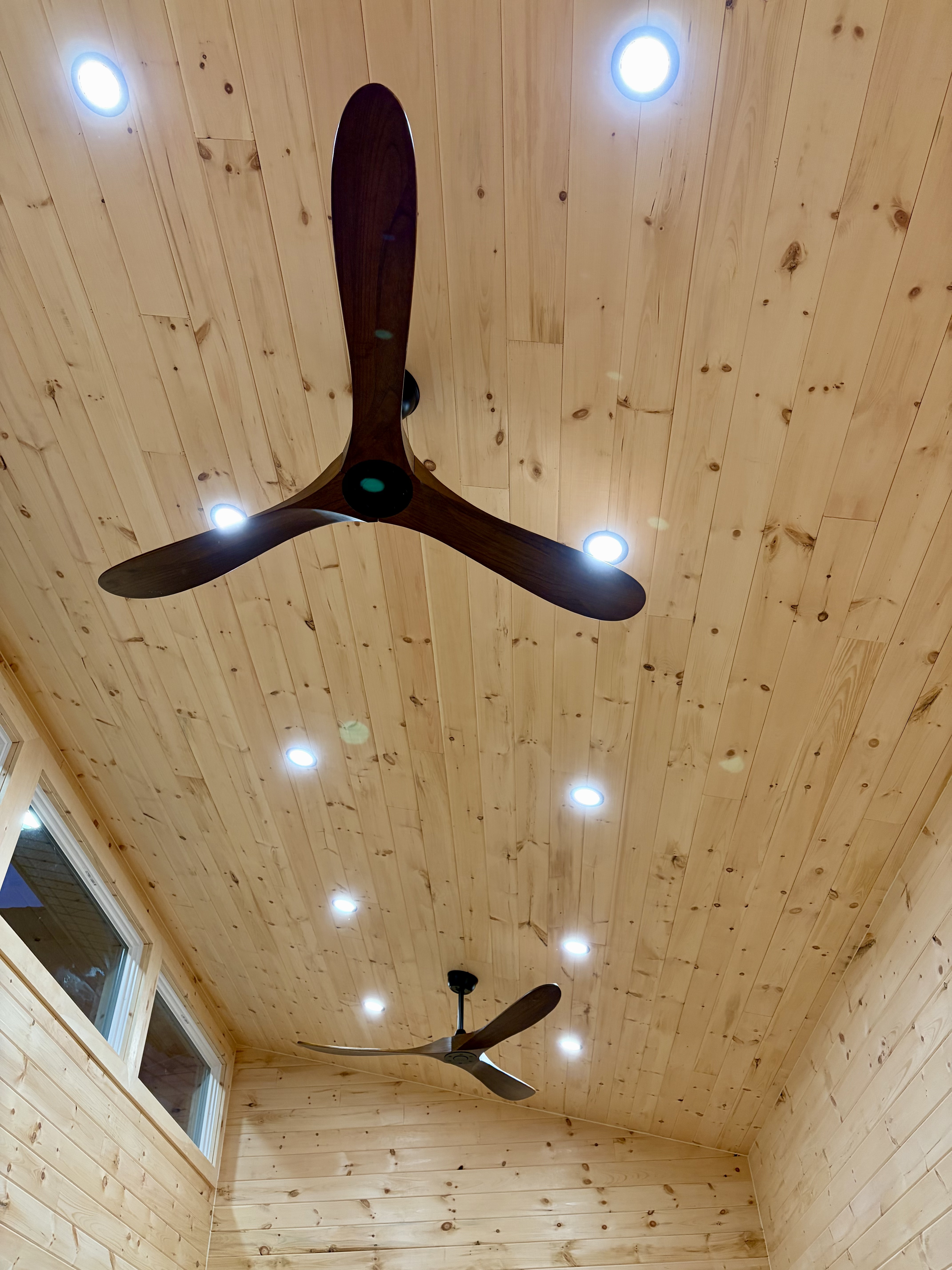 Pine ceiling with ceiling fans and pot lights