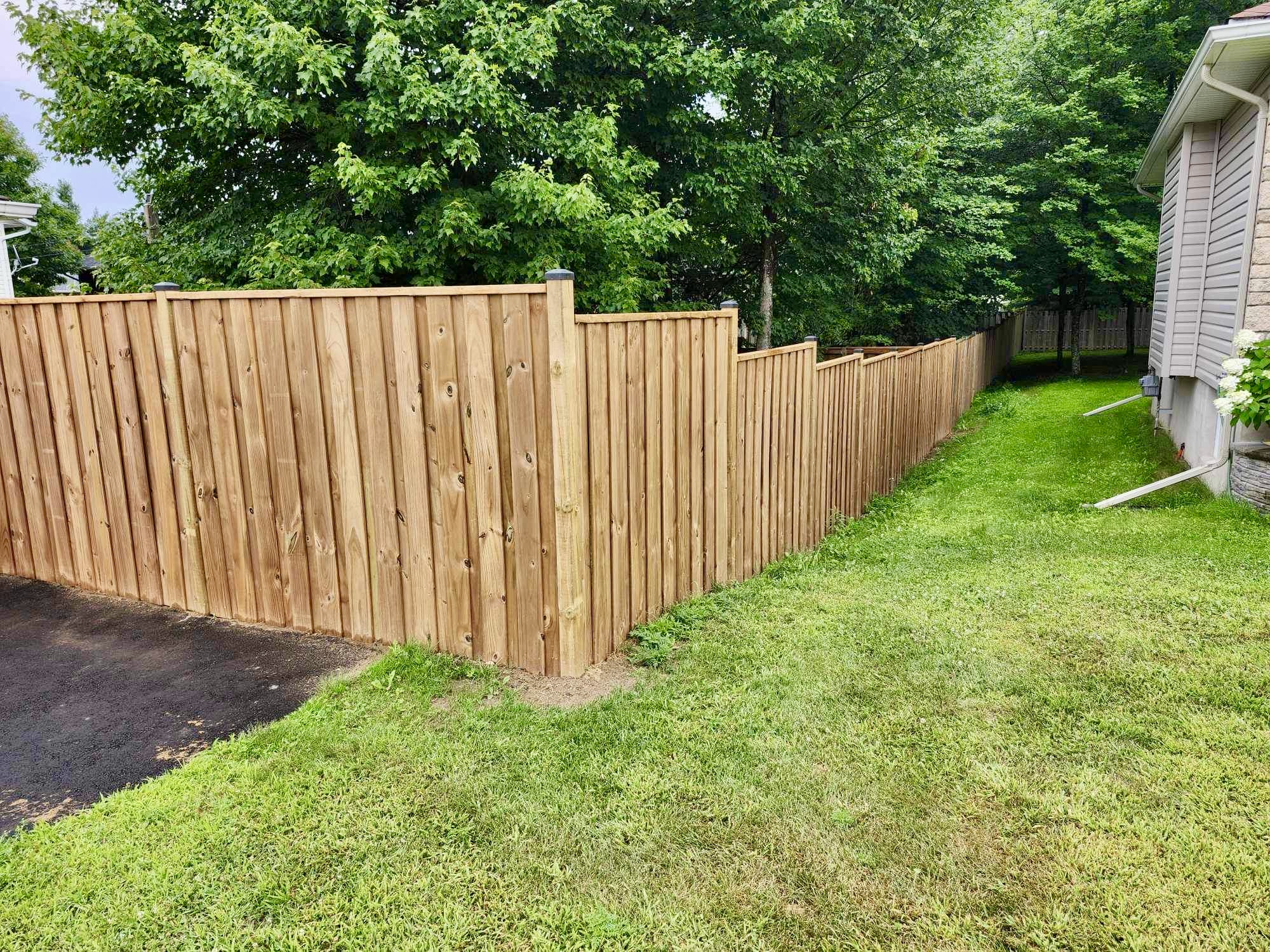 Long cedar fence along property line