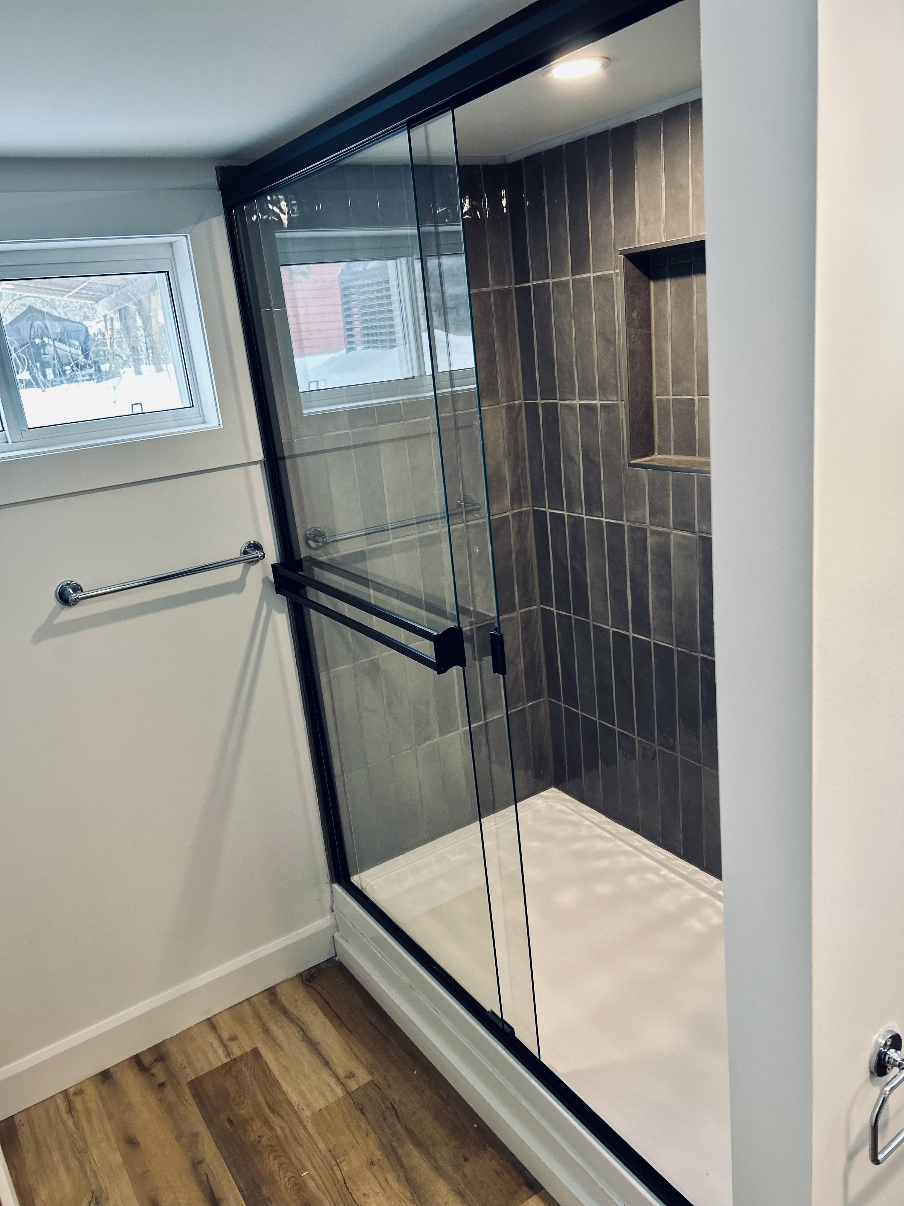Dark tile shower with built-in niche