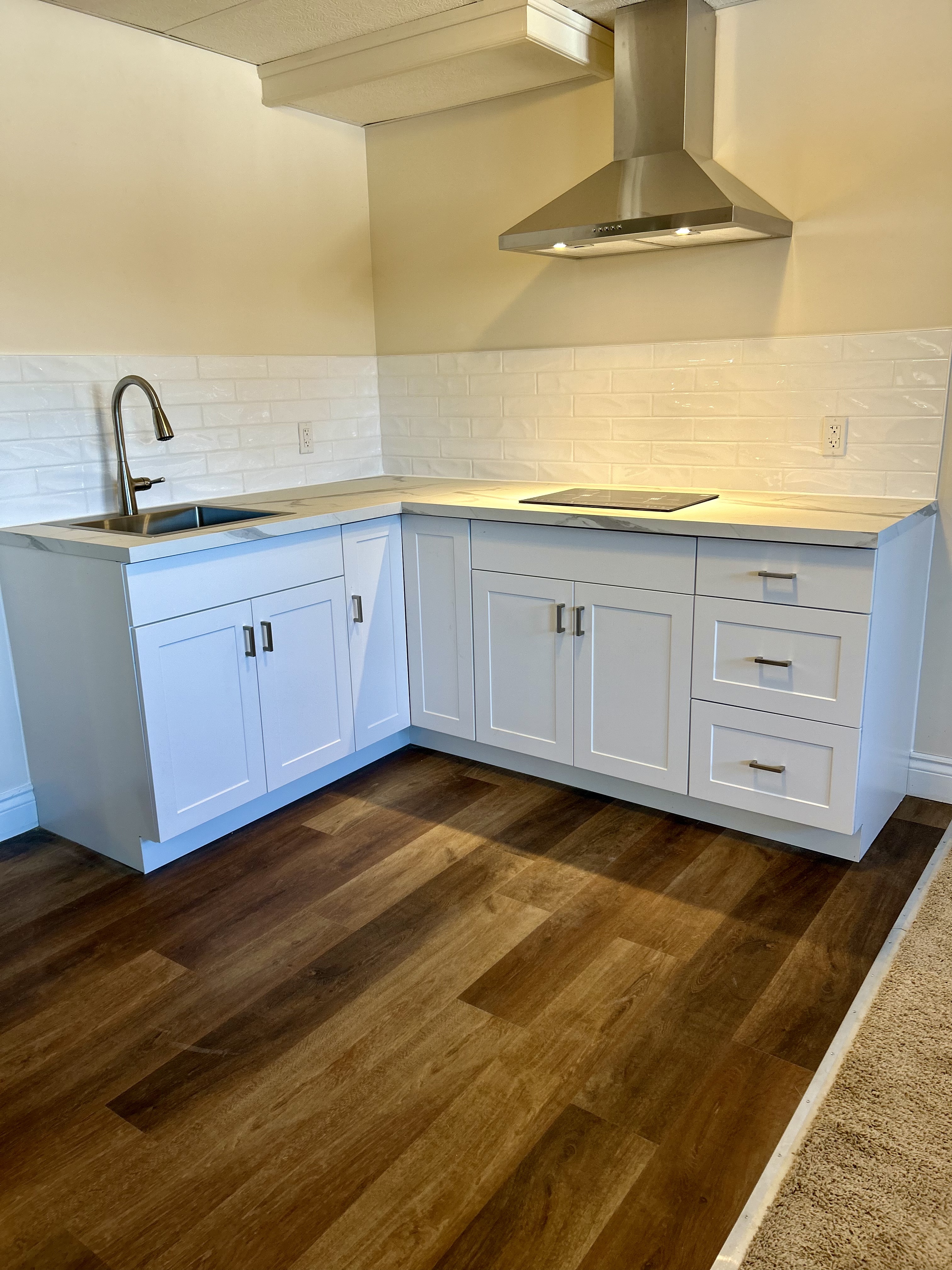 Kitchen renovation with white cabinets and backsplash
