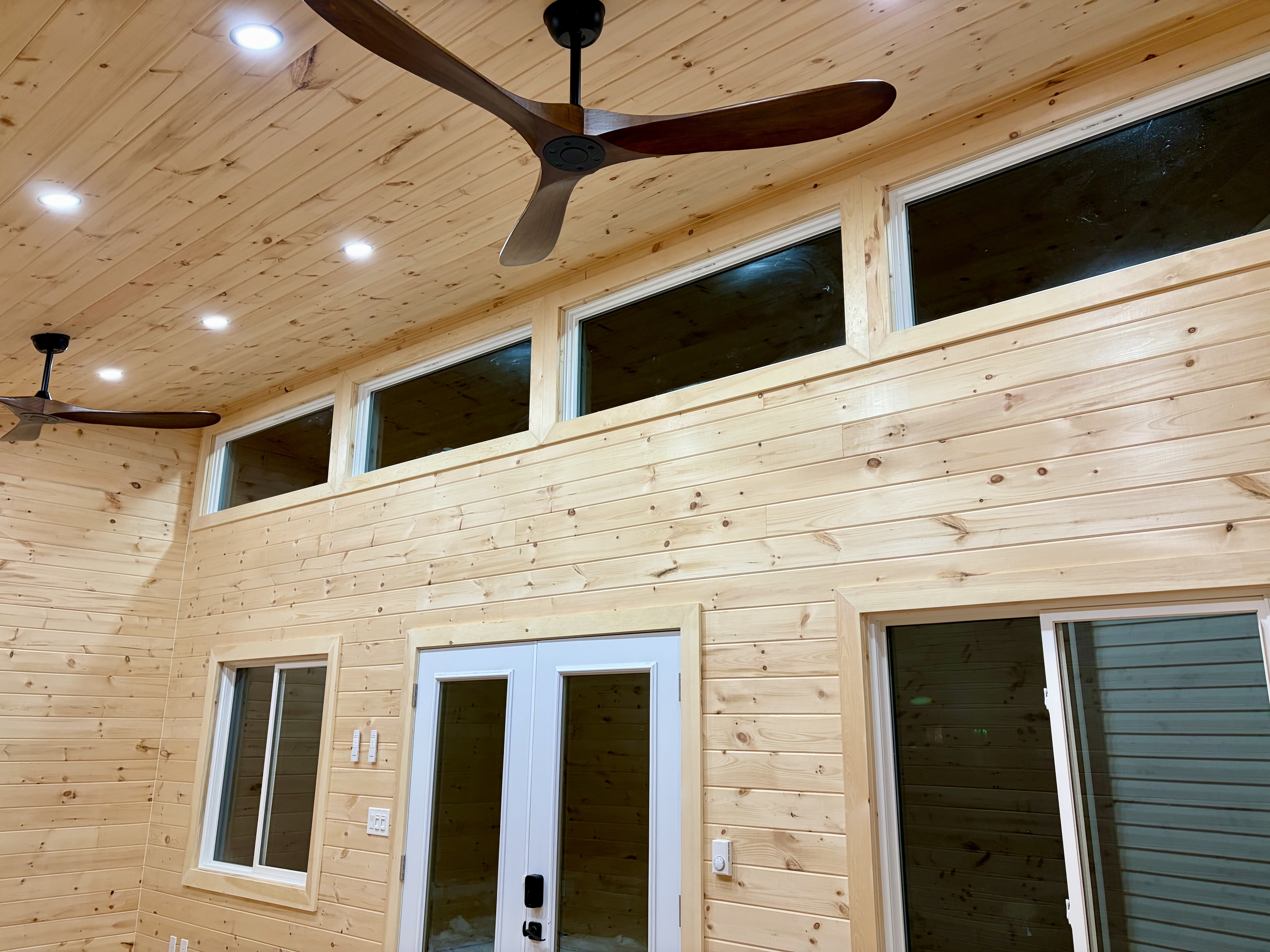 Interior with pine walls and ceiling fans