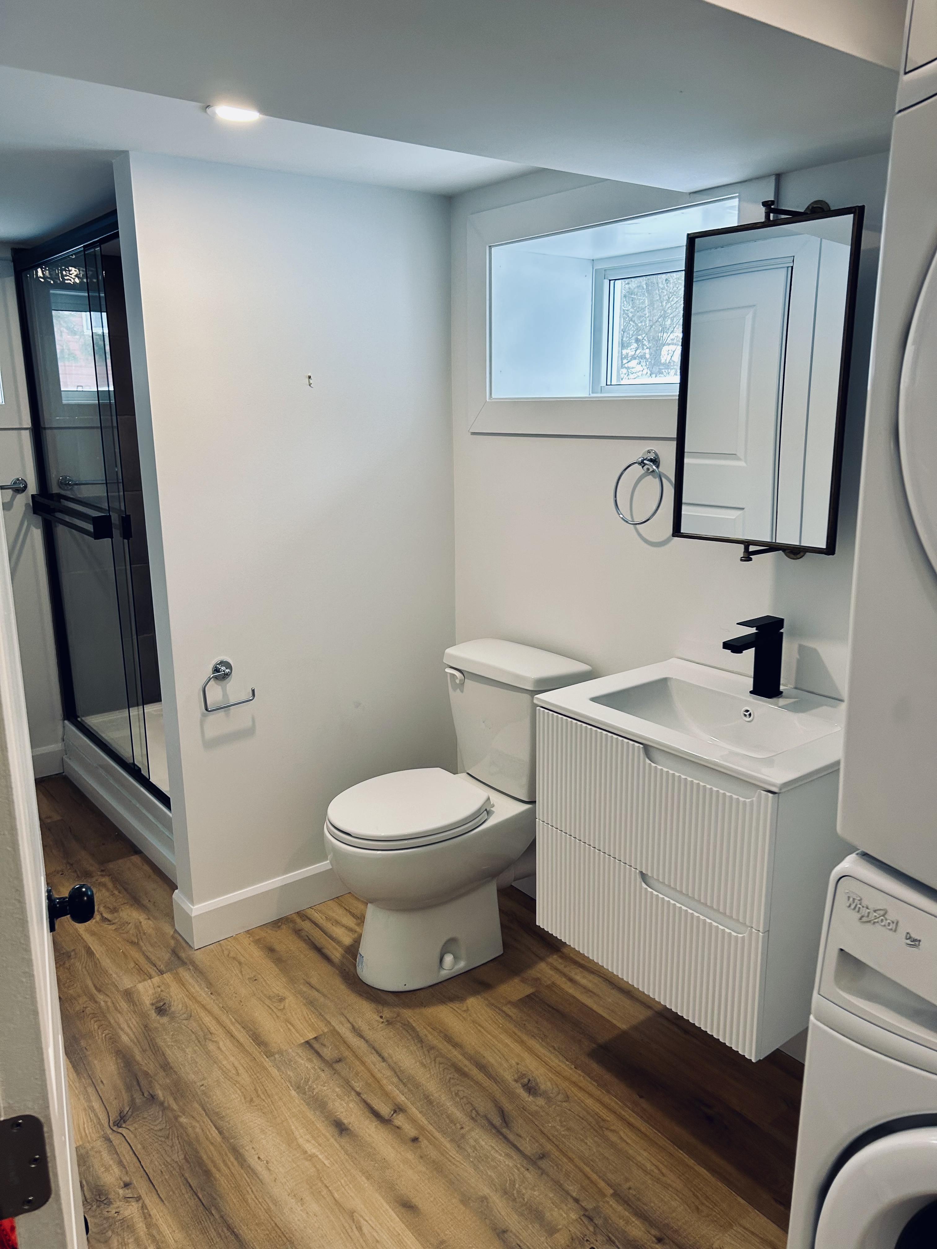 Modern bathroom with vanity and black frame shower
