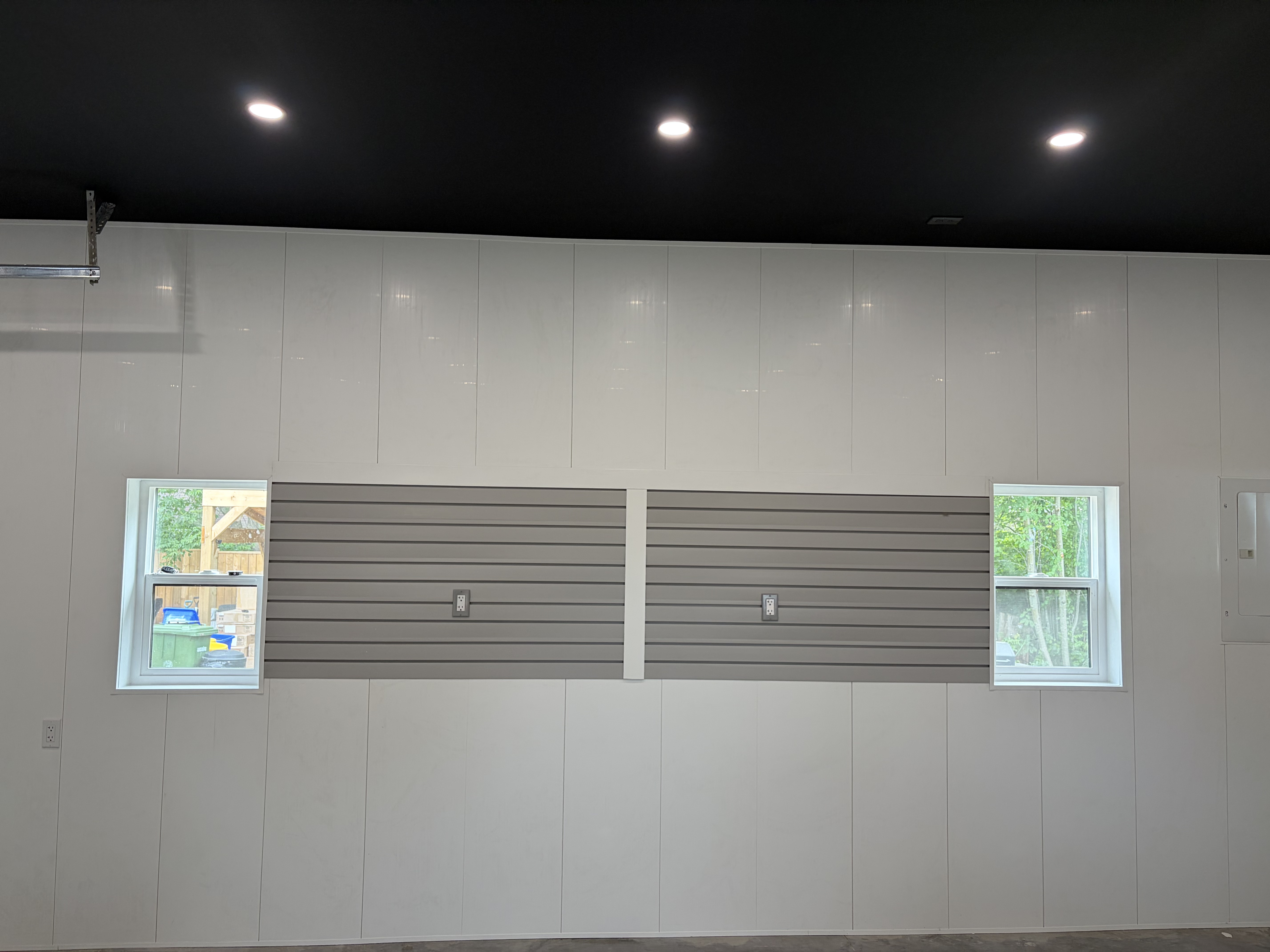 Garage interior wall with slatwall panels and windows