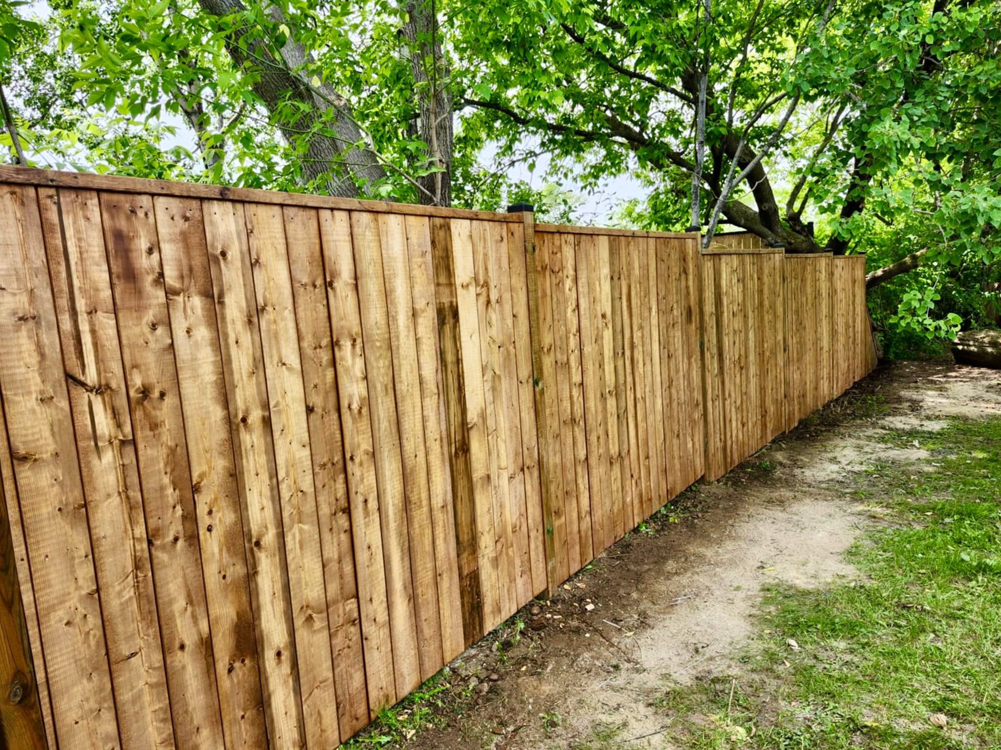 Privacy fence along tree line