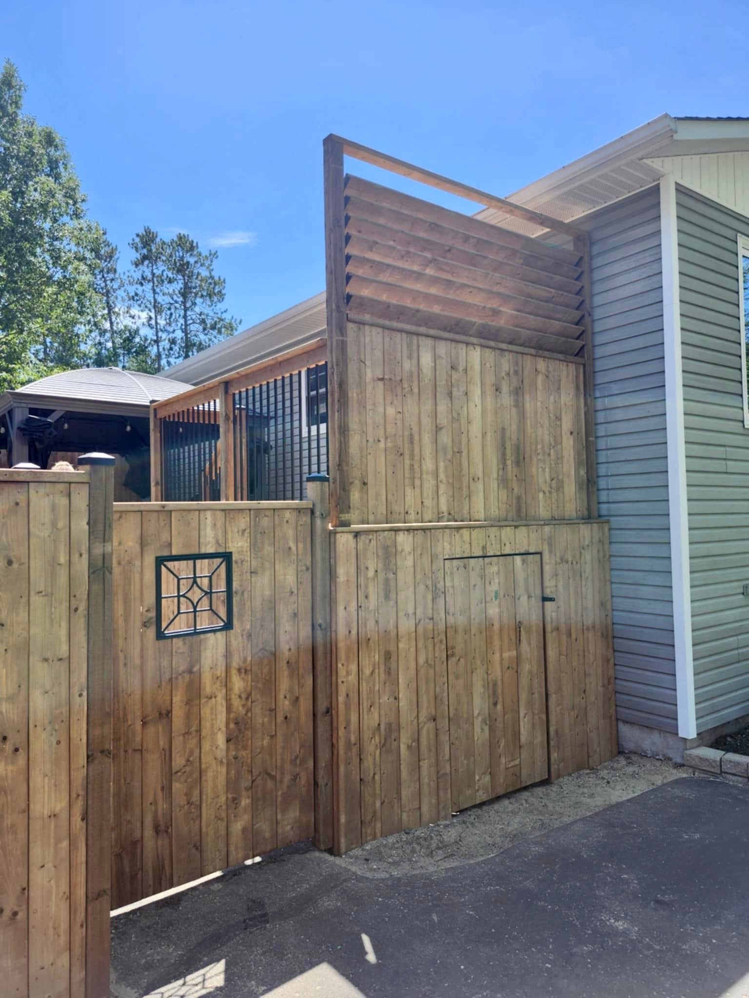 Custom fence with pergola gate and storage