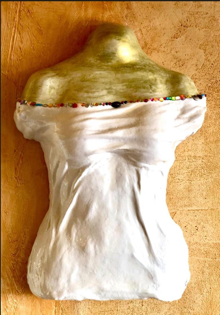 White draped bust with gold shoulders and beaded neckline