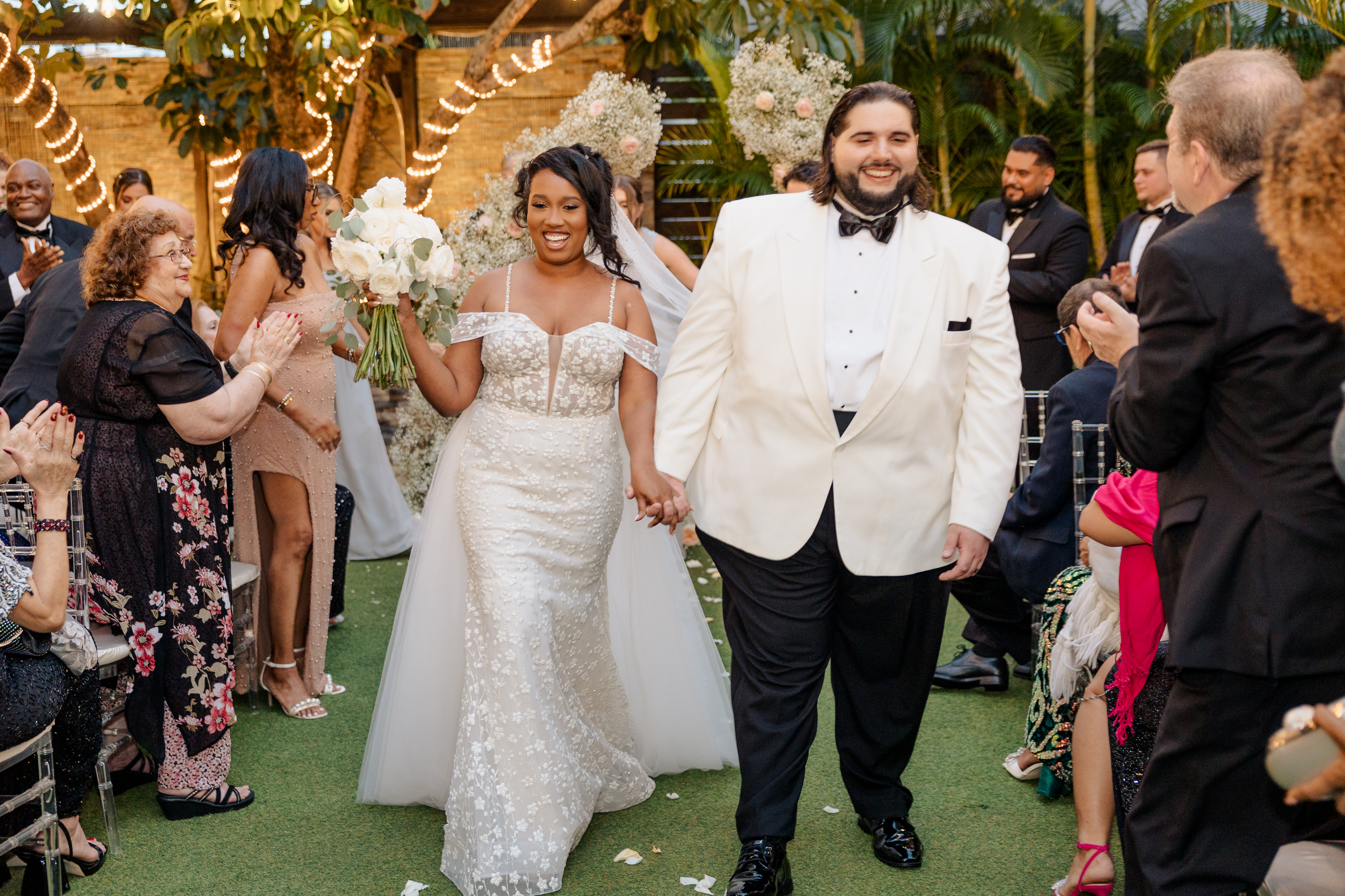 Bride and groom walking down the aisle at an outdoor wedding — JM Weddings Events