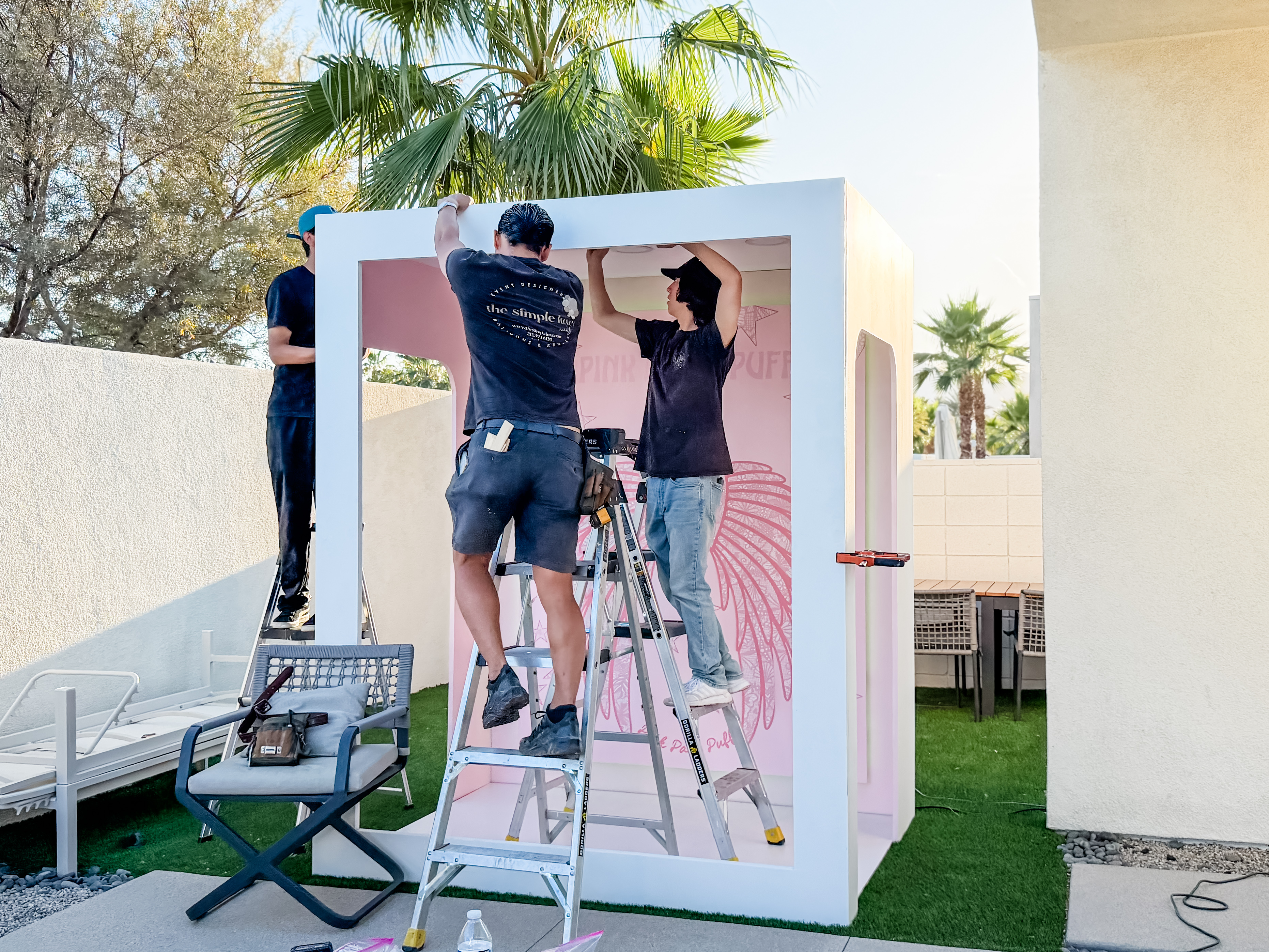 Team assembling a custom branded booth on location