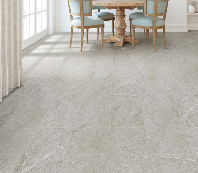 Bright dining area with light grey luxury vinyl tile flooring in staggered pattern