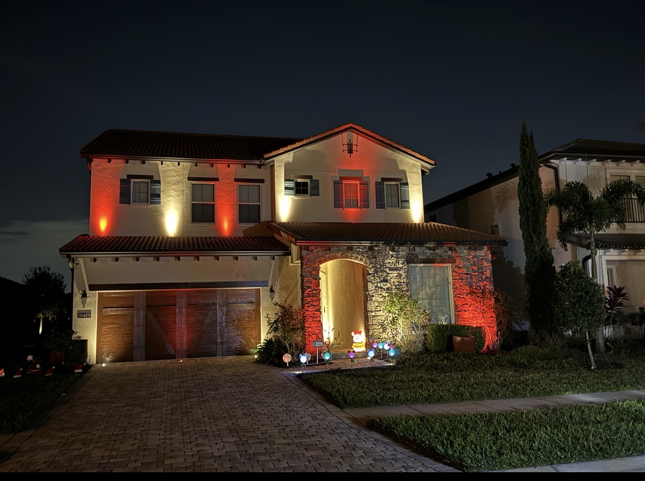 Royal Cypress Preserve Orlando two-story Mediterranean home with RGBW red orange architectural uplighting by LED Artistry near Disney World