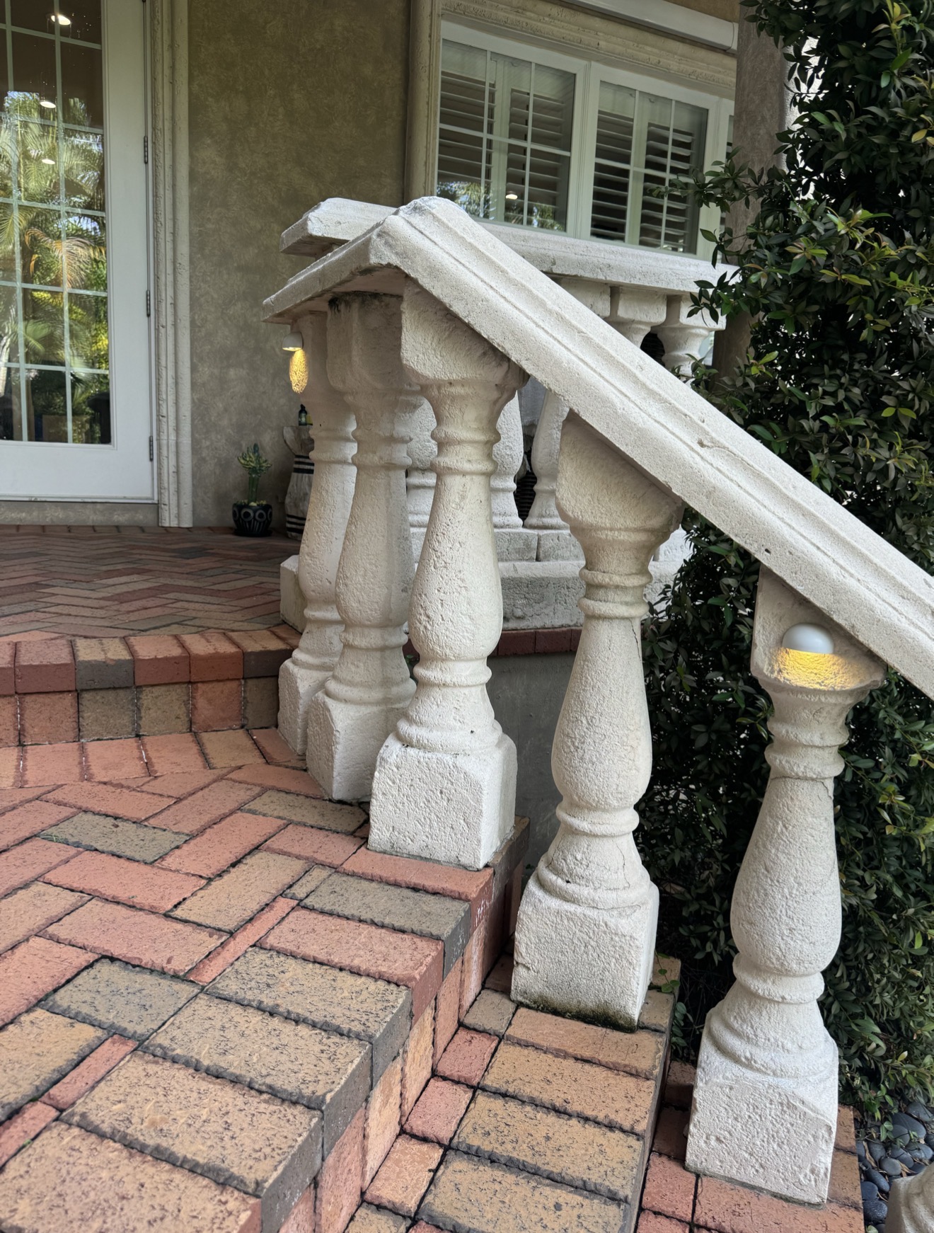 Concrete balustrade with concealed LED fixture at base — hardscape lighting installation detail by LED Artistry Tampa Bay