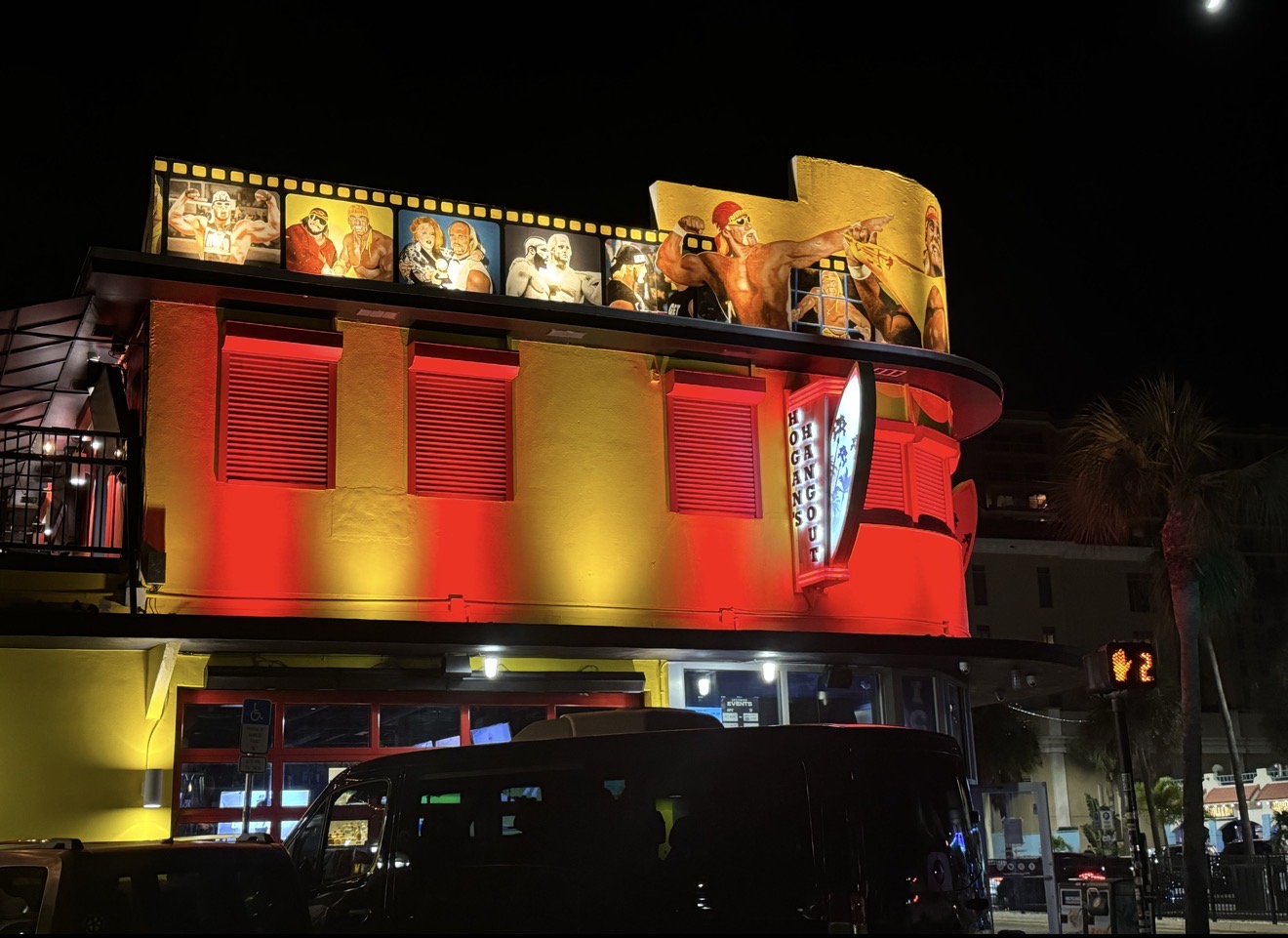 Hogan's Hangout Clearwater Beach full building RGBW red and yellow LED lighting at night — LED Artistry installation on Mandalay Avenue