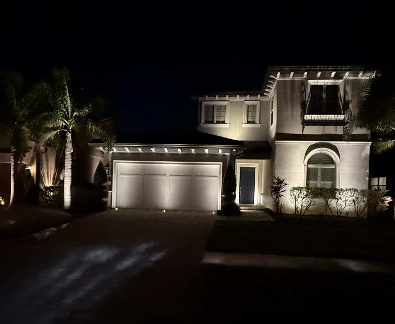 Royal Cypress Preserve Orlando two-story luxury home with warm white architectural LED uplighting, palm uplighting, pergola accent lighting by LED Artistry