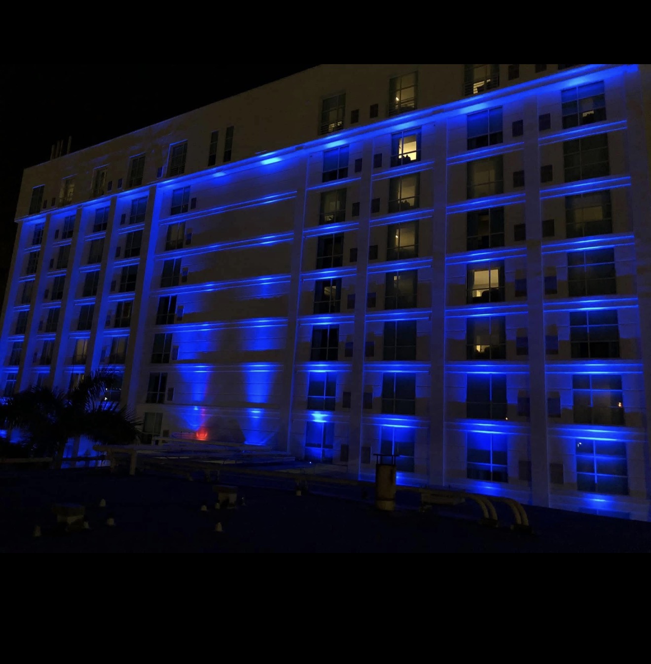 Hotel Alba Tampa side wing with floor-by-floor RGBW blue LED cornice uplighting at night by LED Artistry