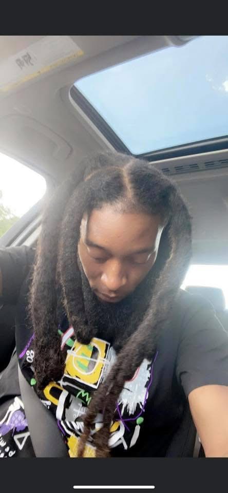 Client showing off styled locs after loc service at Pure Masters Lounge Rochester NY Client showing off styled locs after loc service at Pure Masters Lounge Rochester NY