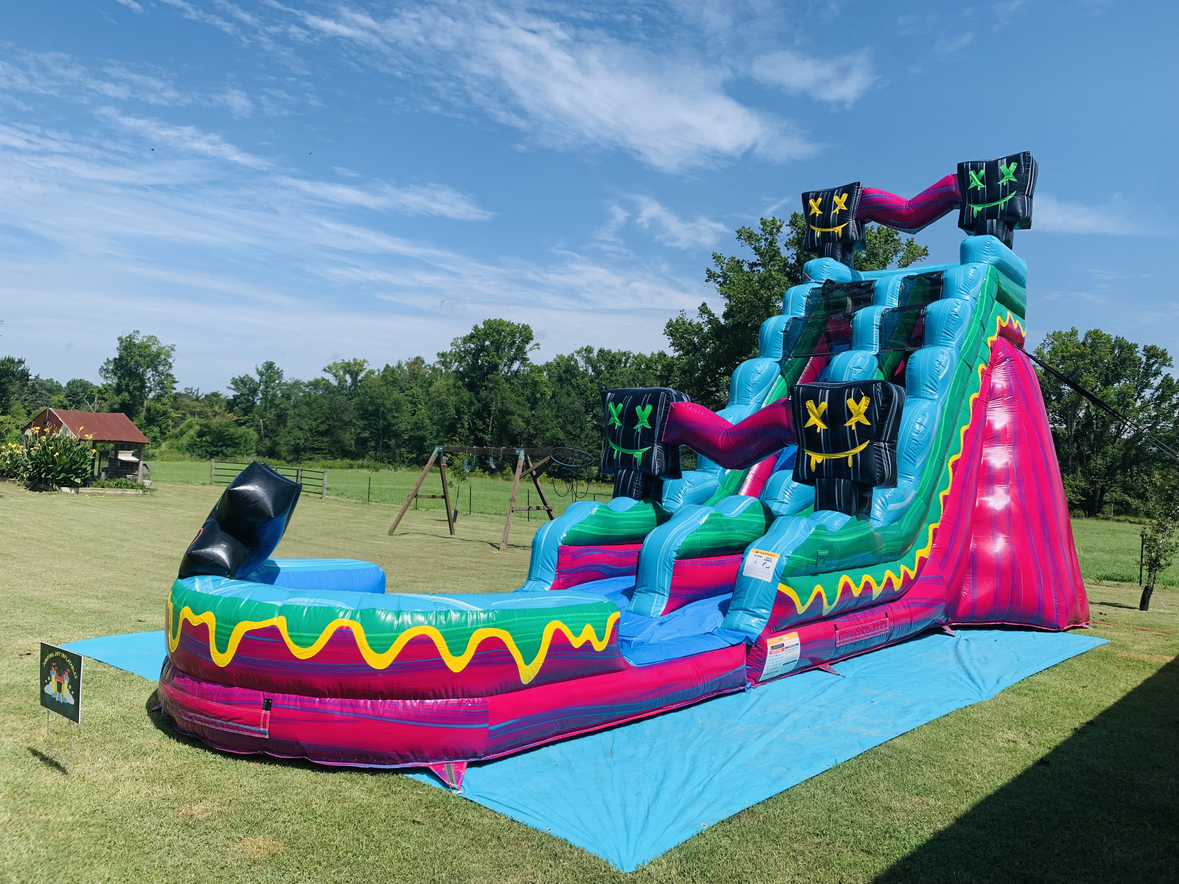 Level Up water slide set up on a sunny day  Jumping Joy Inflatables