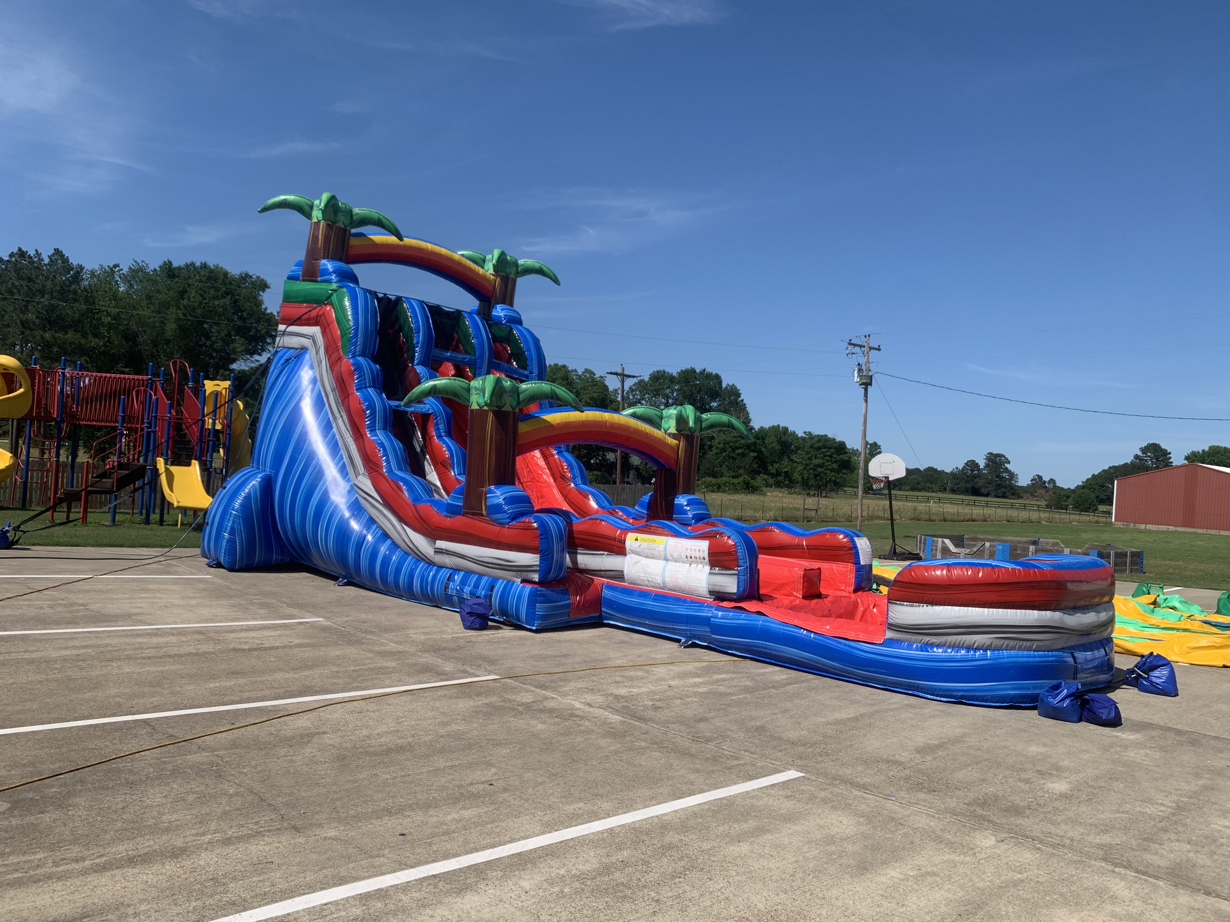 Riptide Rush dual lane water slide set up at a school event