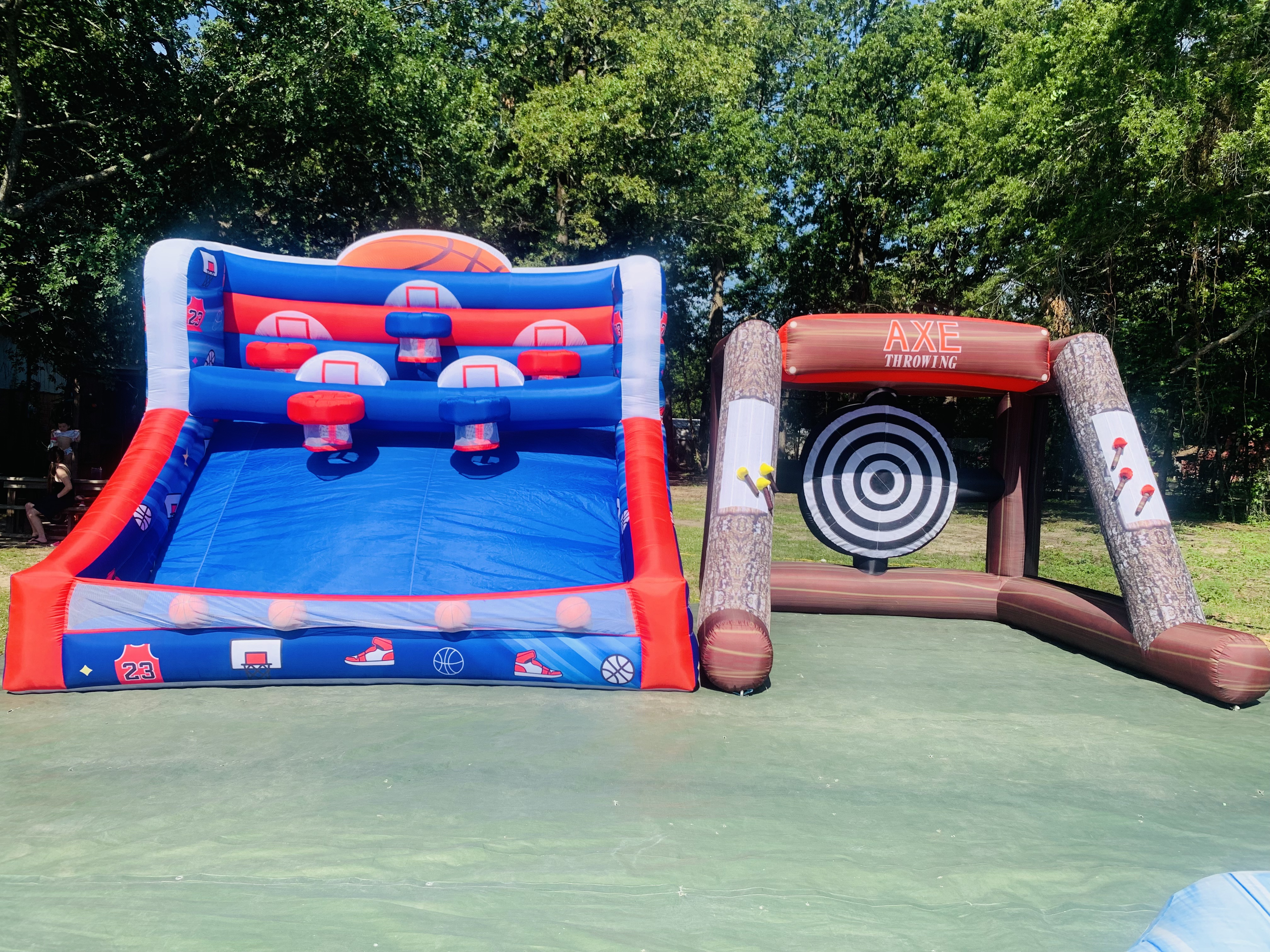 Basketball shootout and Axe Throwing inflatable games set up on a court