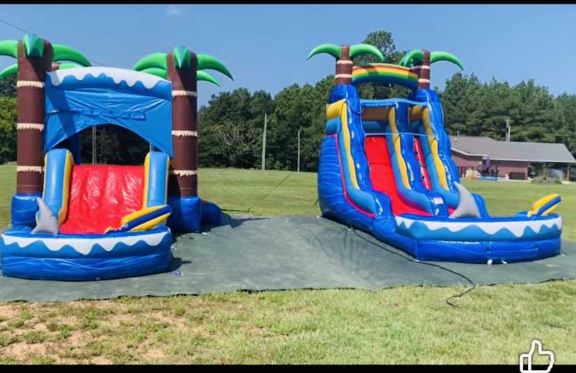 Shark Attack combo unit and Baja Splash dual lane water slide set up side by side on green grass