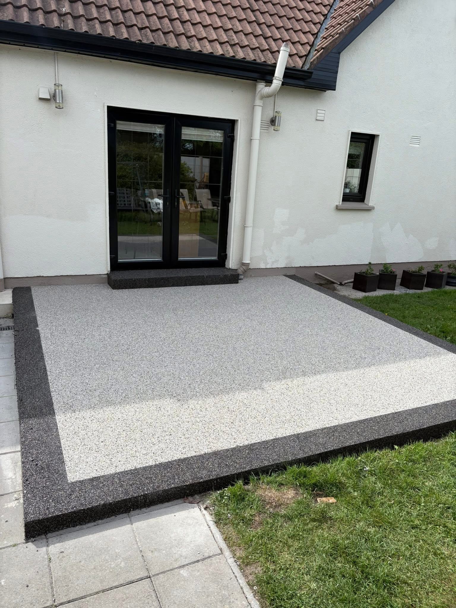 Resin bound patio with dark grey border and silver grey centre — rear garden Dublin