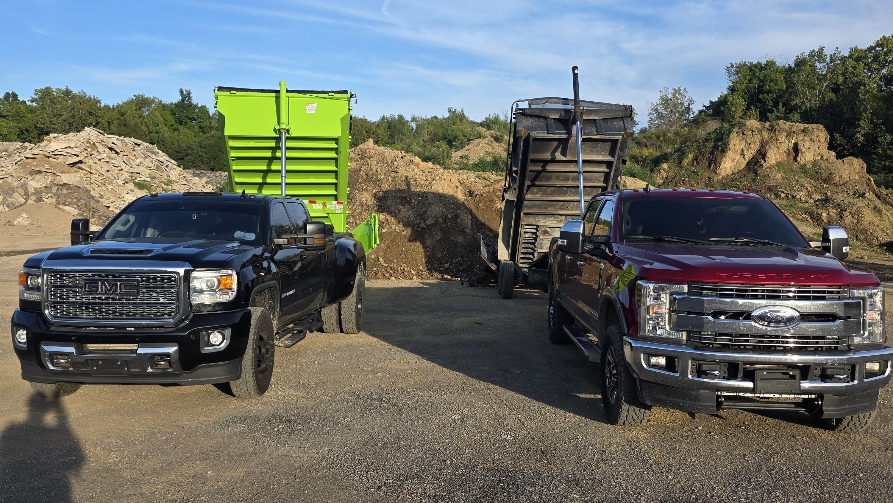 Two JT Ground Pounders dump trailer rigs at a material yard with loads dumped