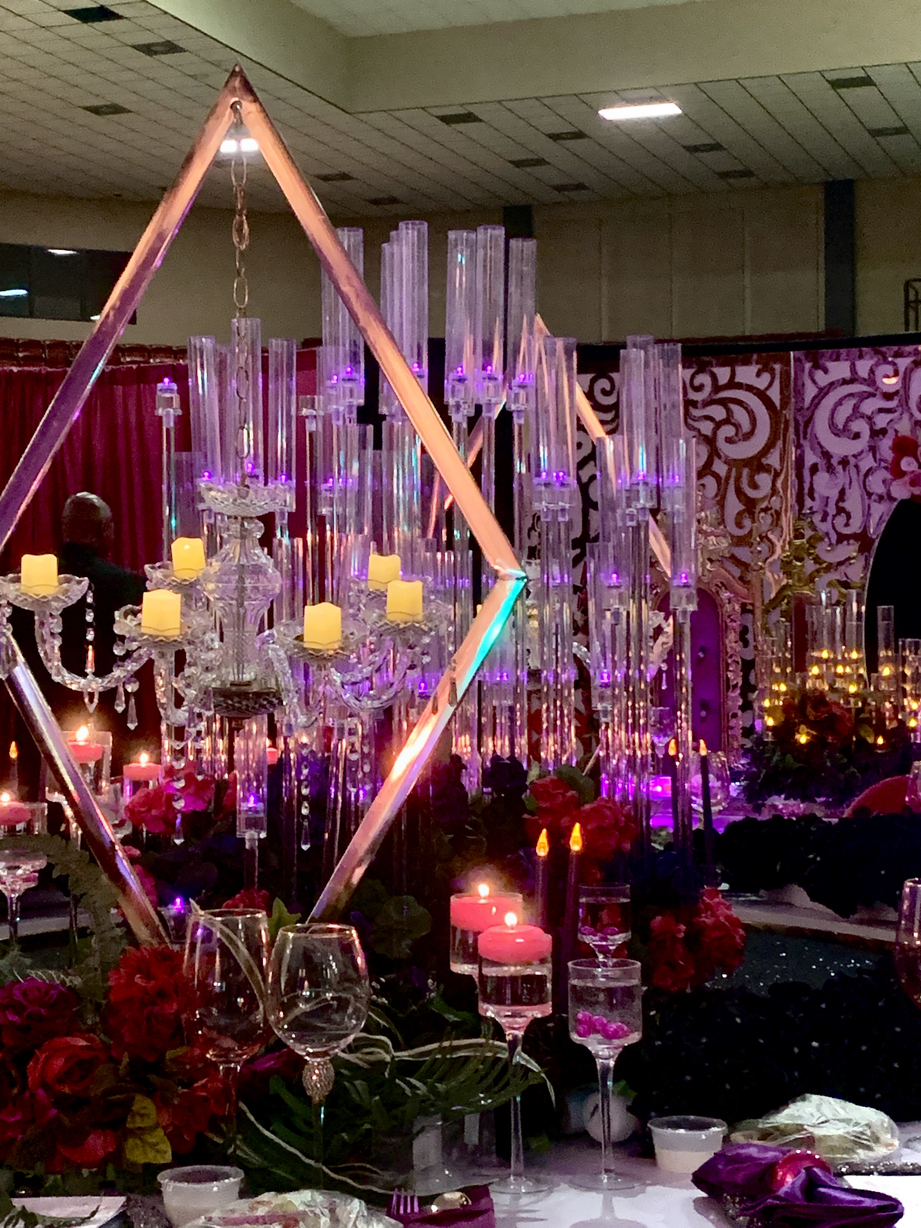 Crystal candelabras and geometric centerpiece with purple lighting