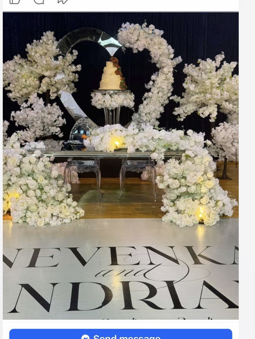 Elegant white floral wedding backdrop with custom dance floor vinyl and cake display