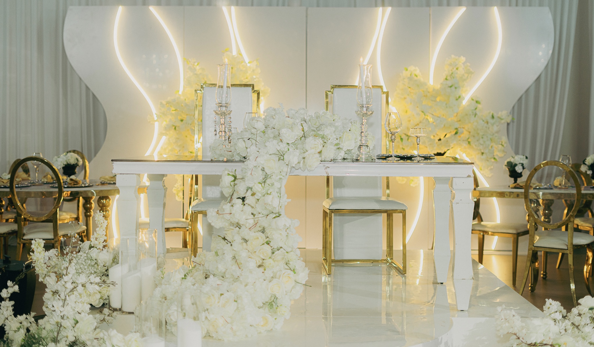 Luxury wedding sweetheart table with white florals and gold accents