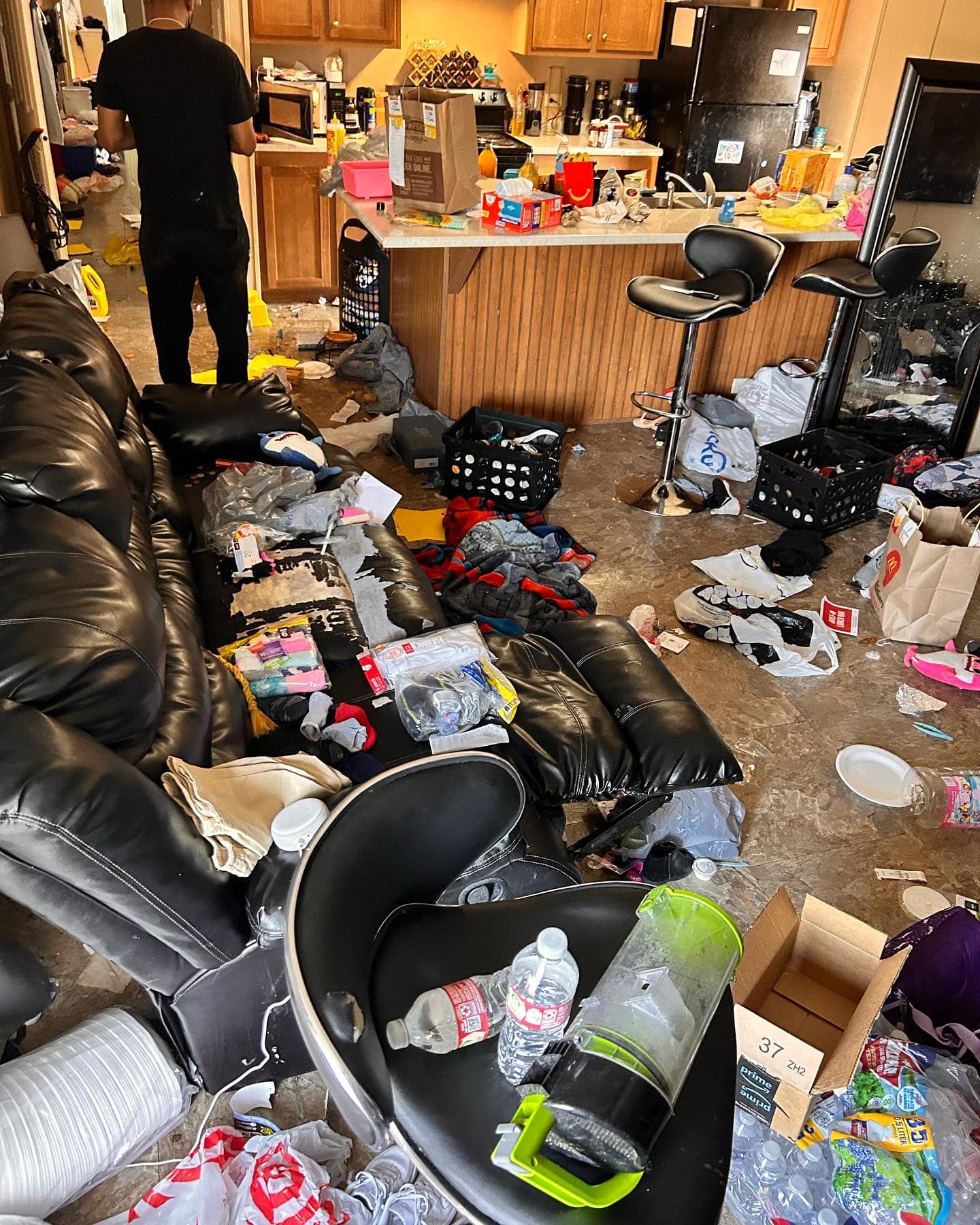 Before cleaning transformation - cluttered kitchen and living area