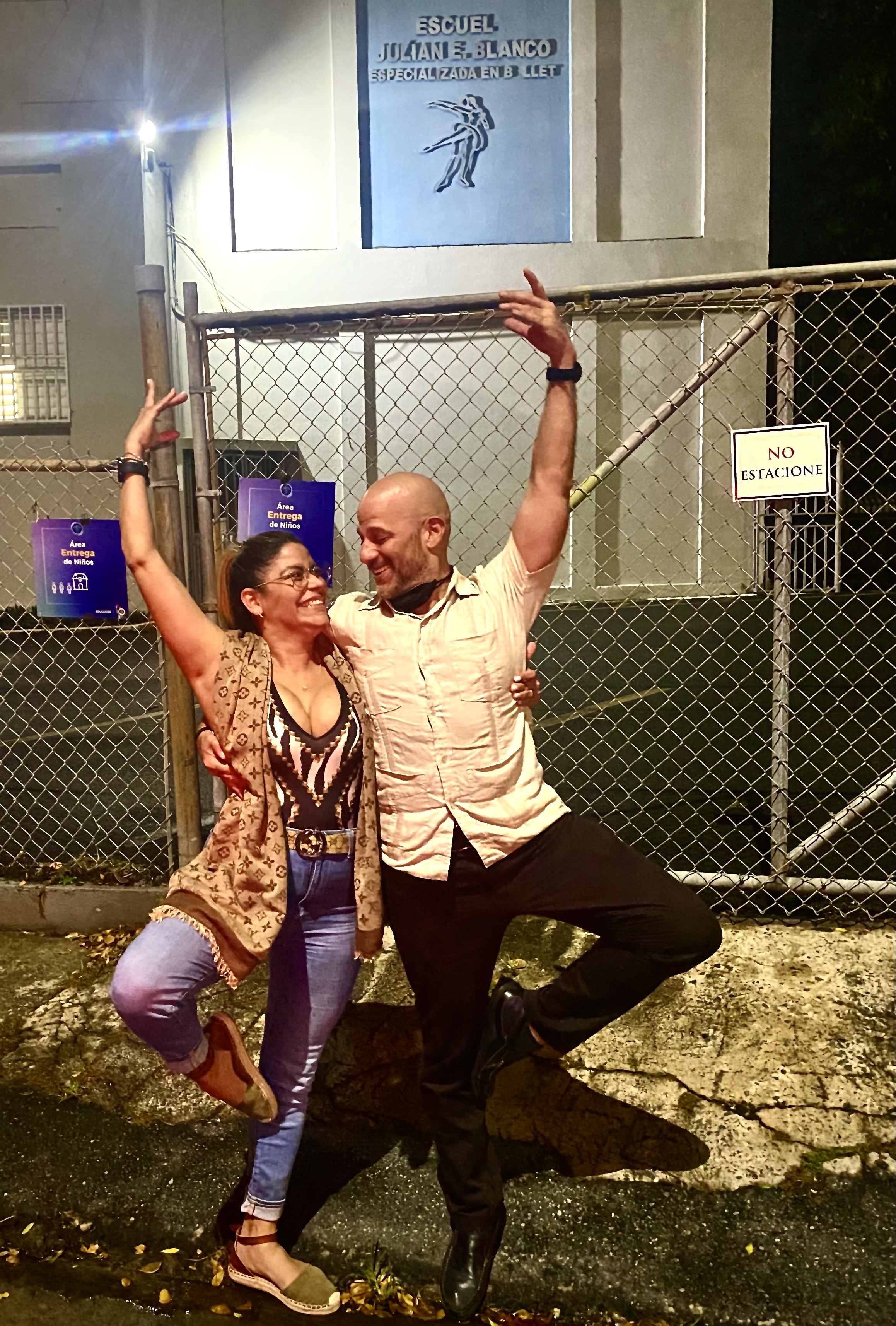 Xavier and a friend striking a dance pose in front of Escuela Julian E. Blanco — the ballet school where Xavier trained