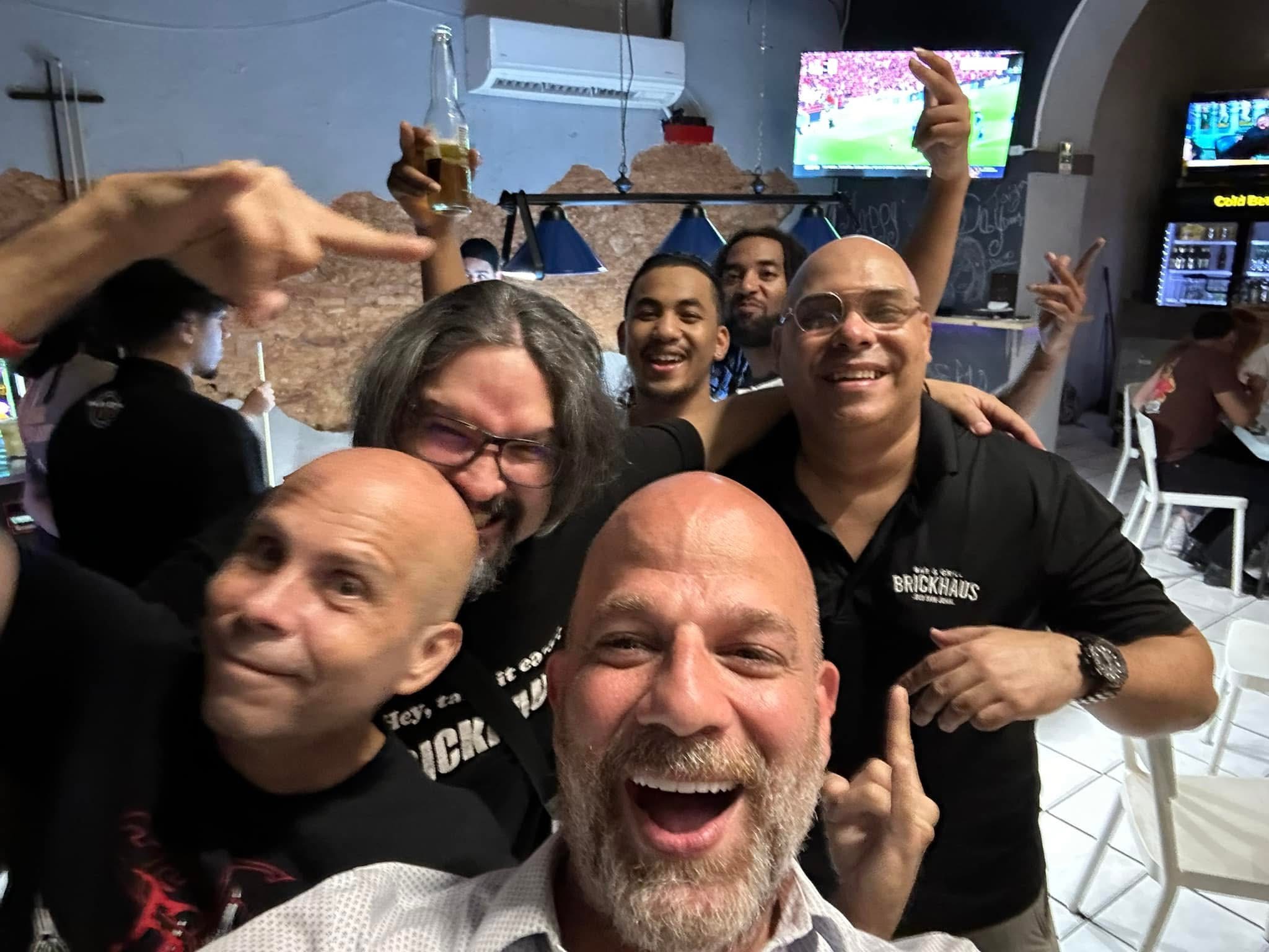 Xavier and the crew at a bar in Puerto Rico — group selfie with big energy