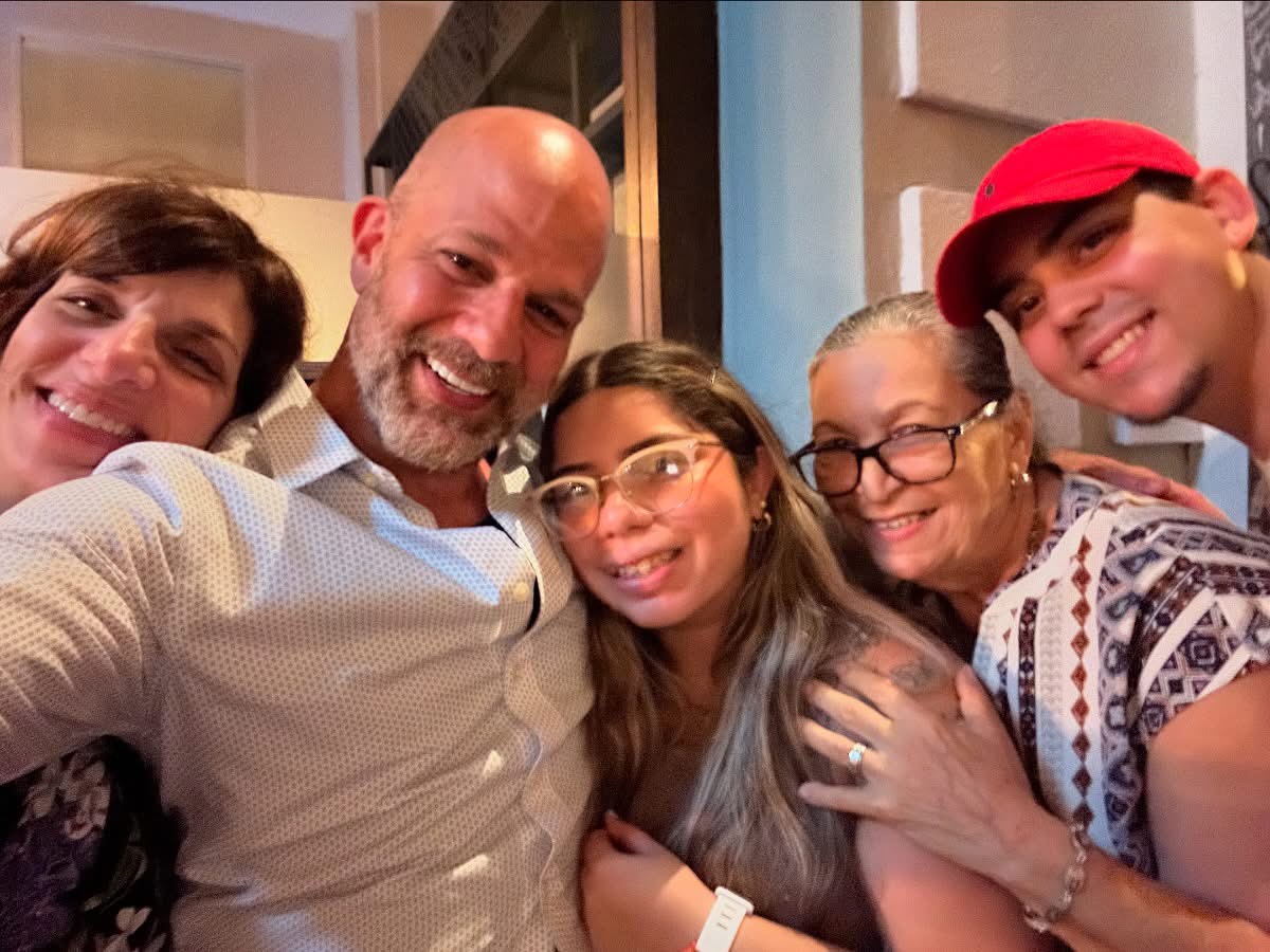 Xavier with family and friends in Puerto Rico — group selfie with warm smiles