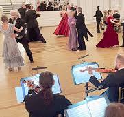 The Waltz Series β violinists performing in the foreground while couples waltz in formal attire in the background, elegant ballroom setting with warm lighting