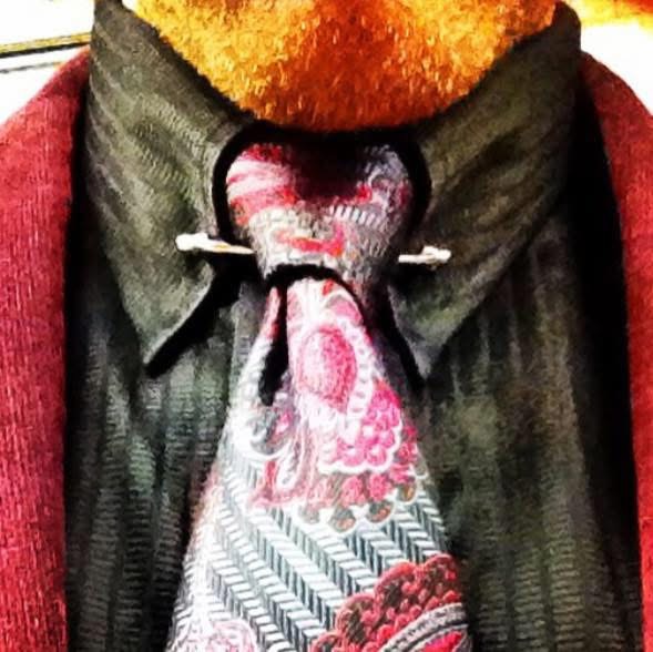 Close-up of a 1920s-style paisley tie with a tie pin on a dark shirt — Prohibition-era style detail