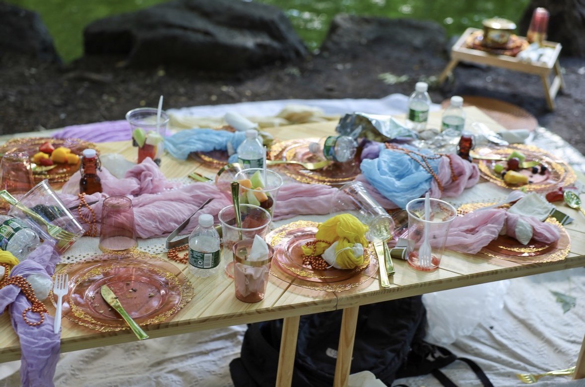 Regency era garden party tablescape \u2014 gold-rimmed plates, pastel scarves, fresh fruit, mocktails at Central Park \u2014 June 7, 2026