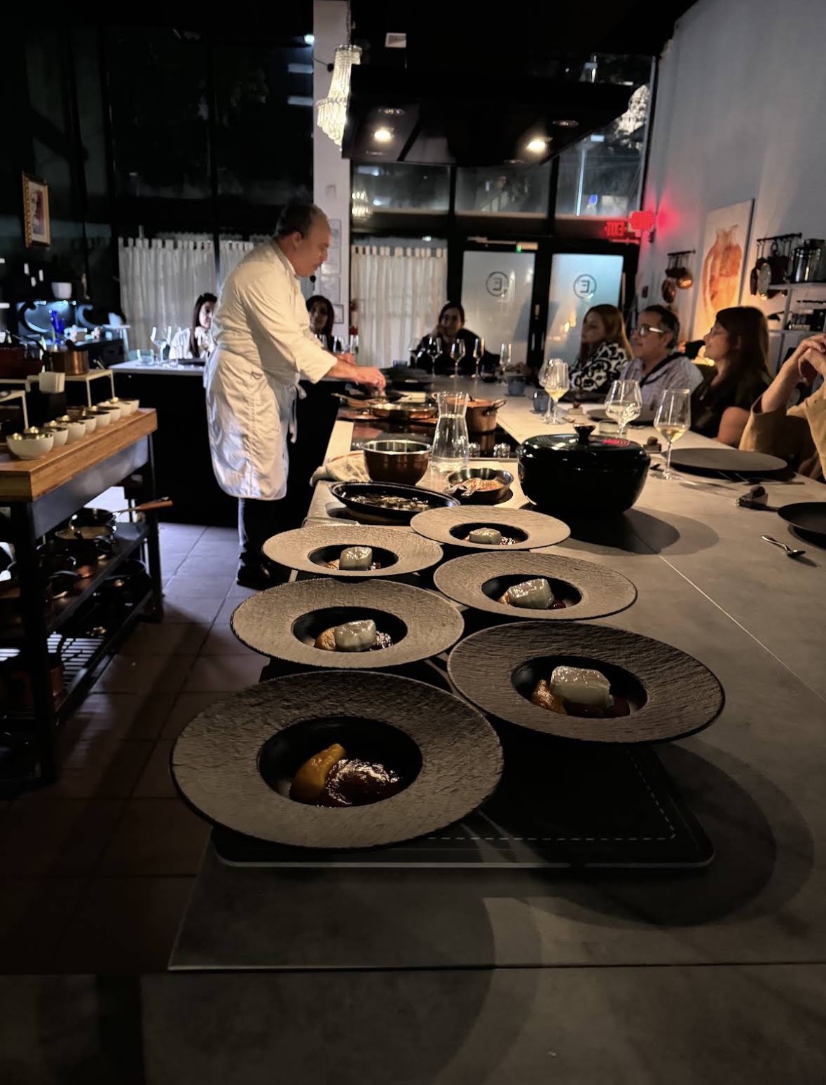 Epicuro Chef's Table — chef plating dishes at the open kitchen