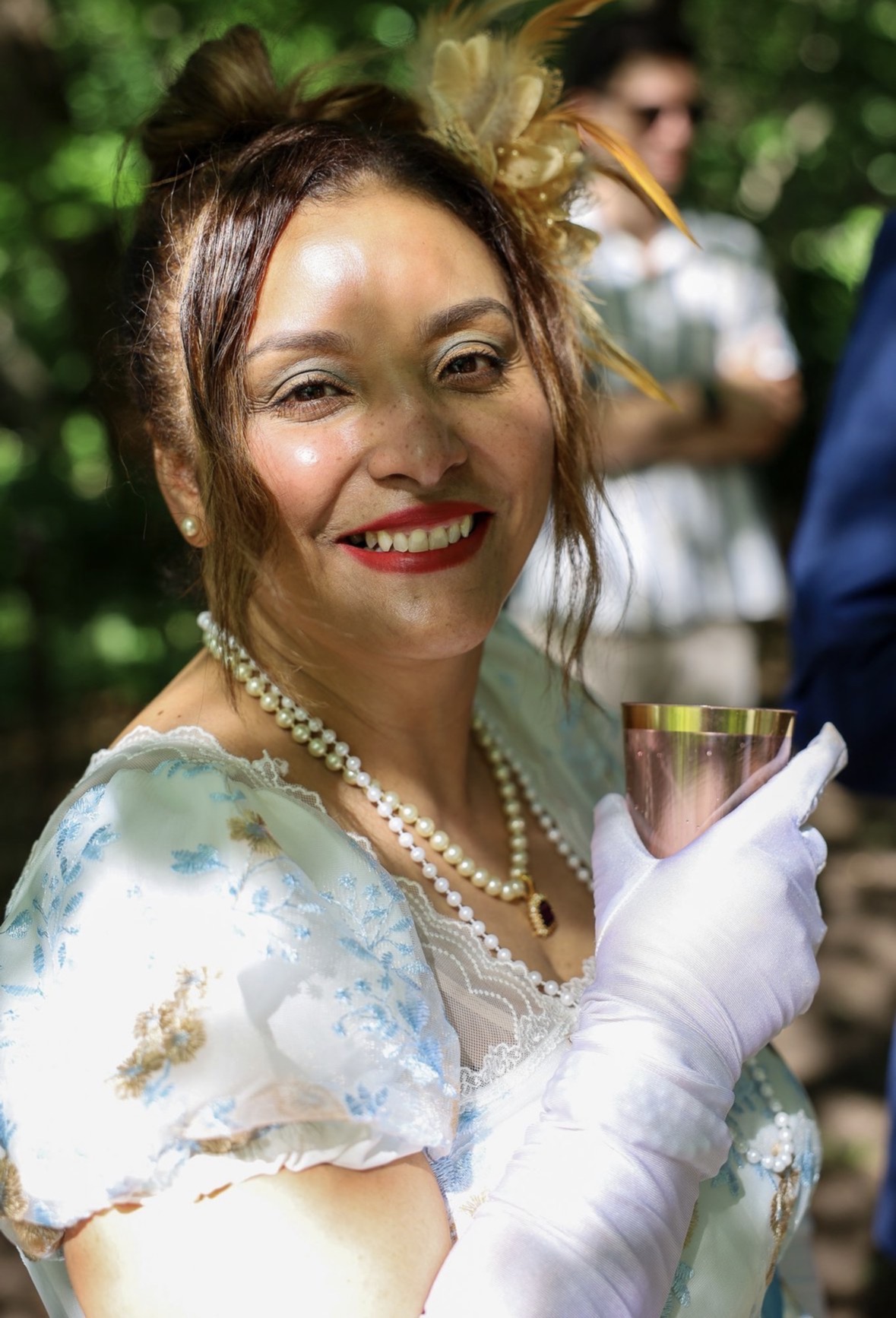 Guest in Regency attire with pearls and white gloves