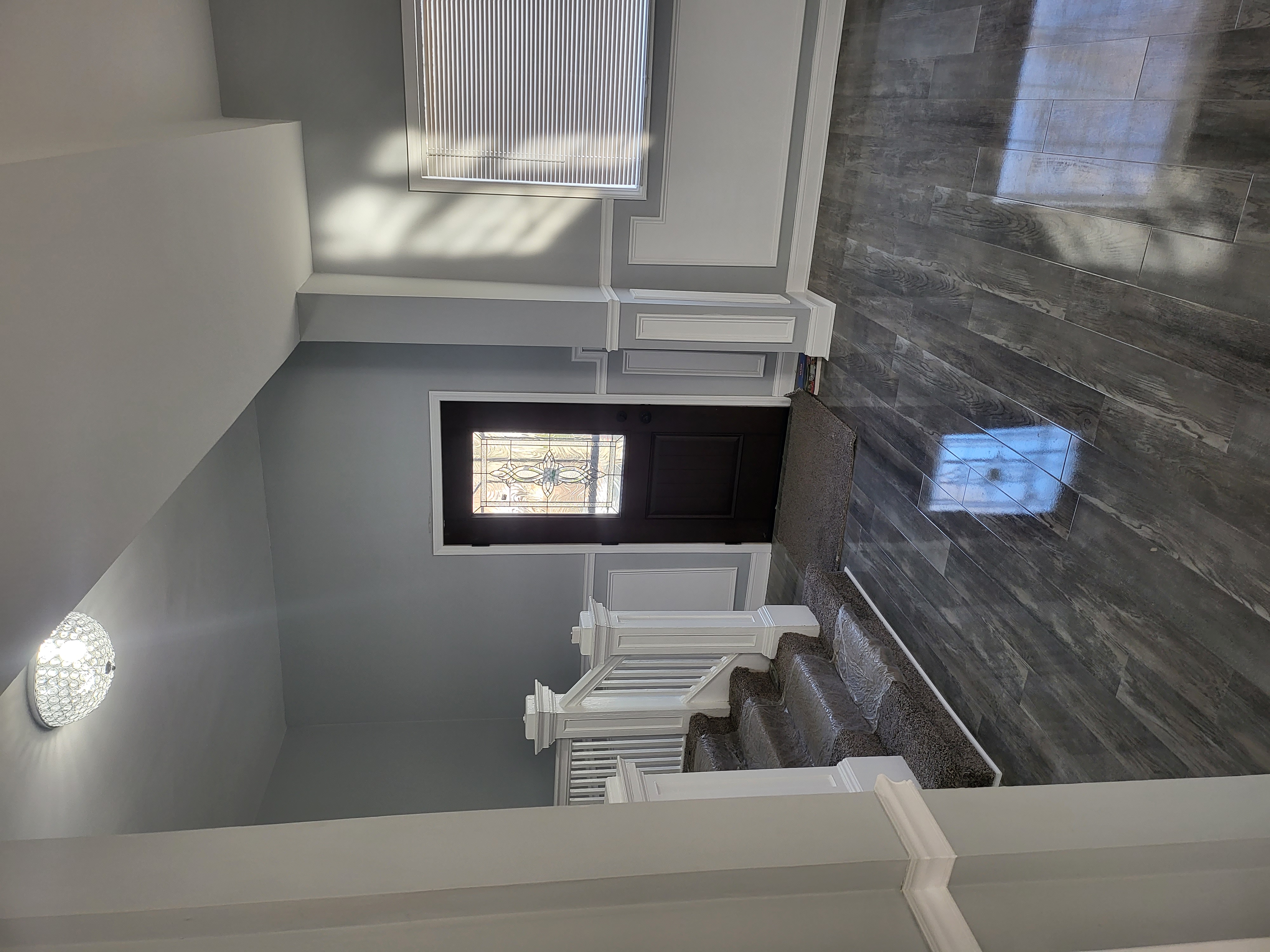Front entry with wainscoting and staircase