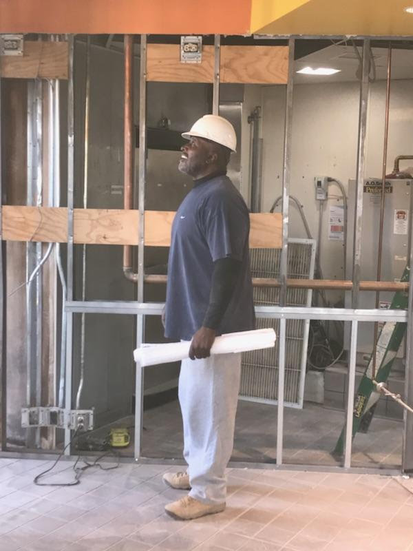 Melvin Buckley on a construction site wearing a hard hat