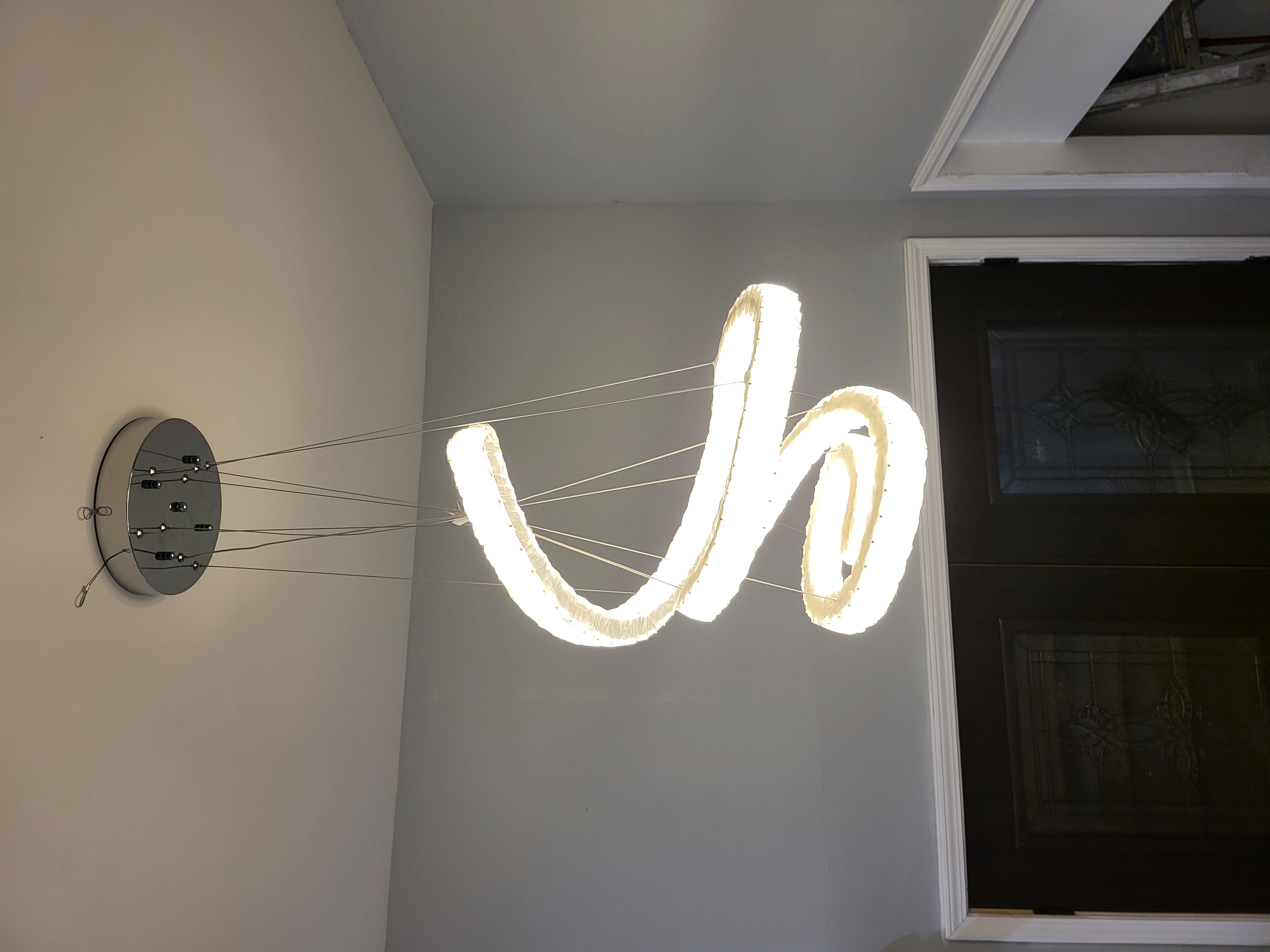 Modern spiral LED chandelier in foyer