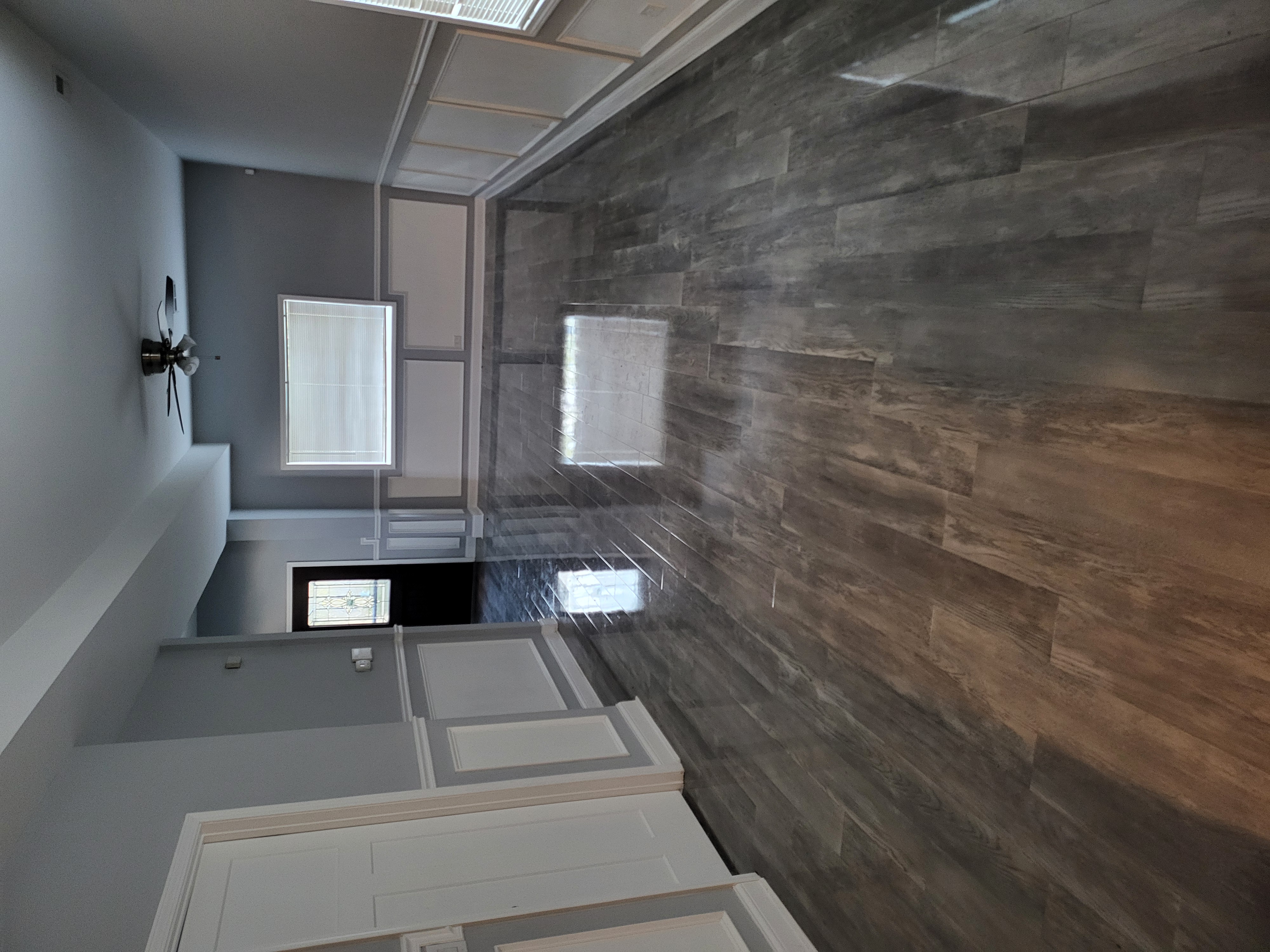Living room with polished wood-look flooring and wainscoting
