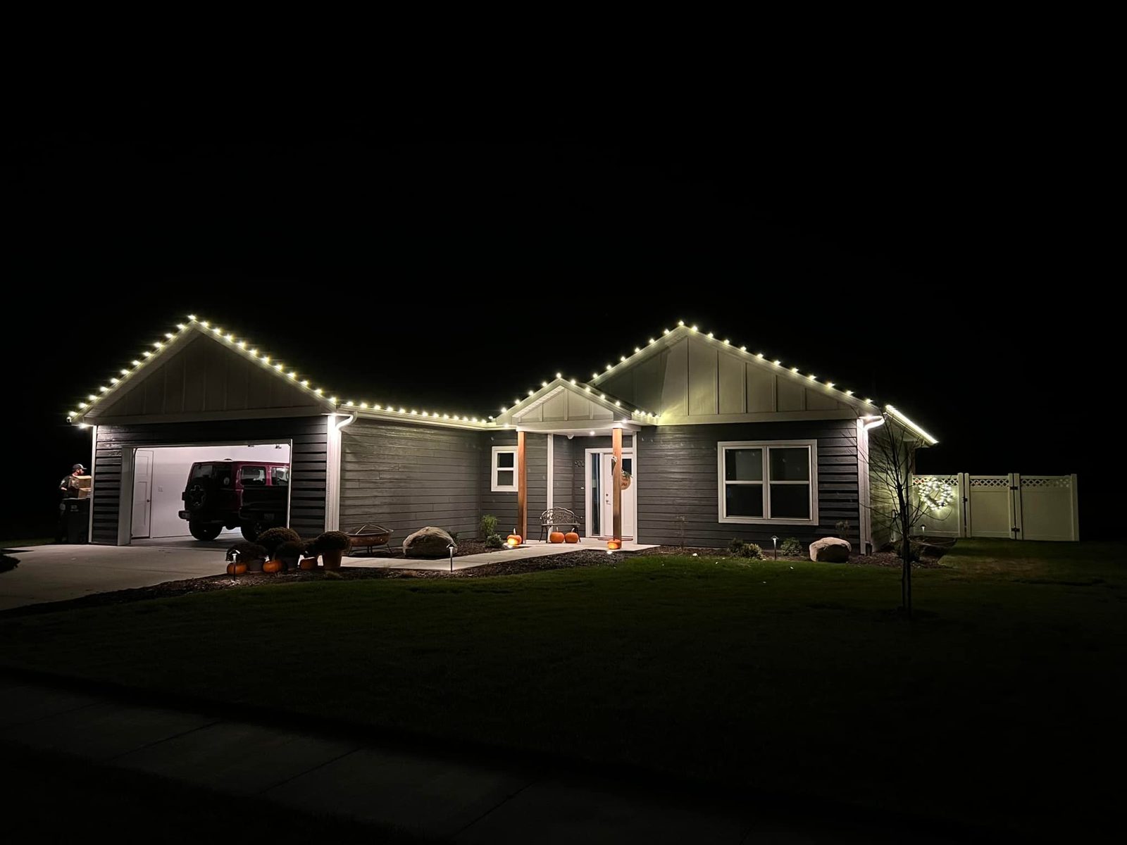 Warm white Christmas lights outlining the roofline of a Nebraska home — professional installation by Lincoln Creek