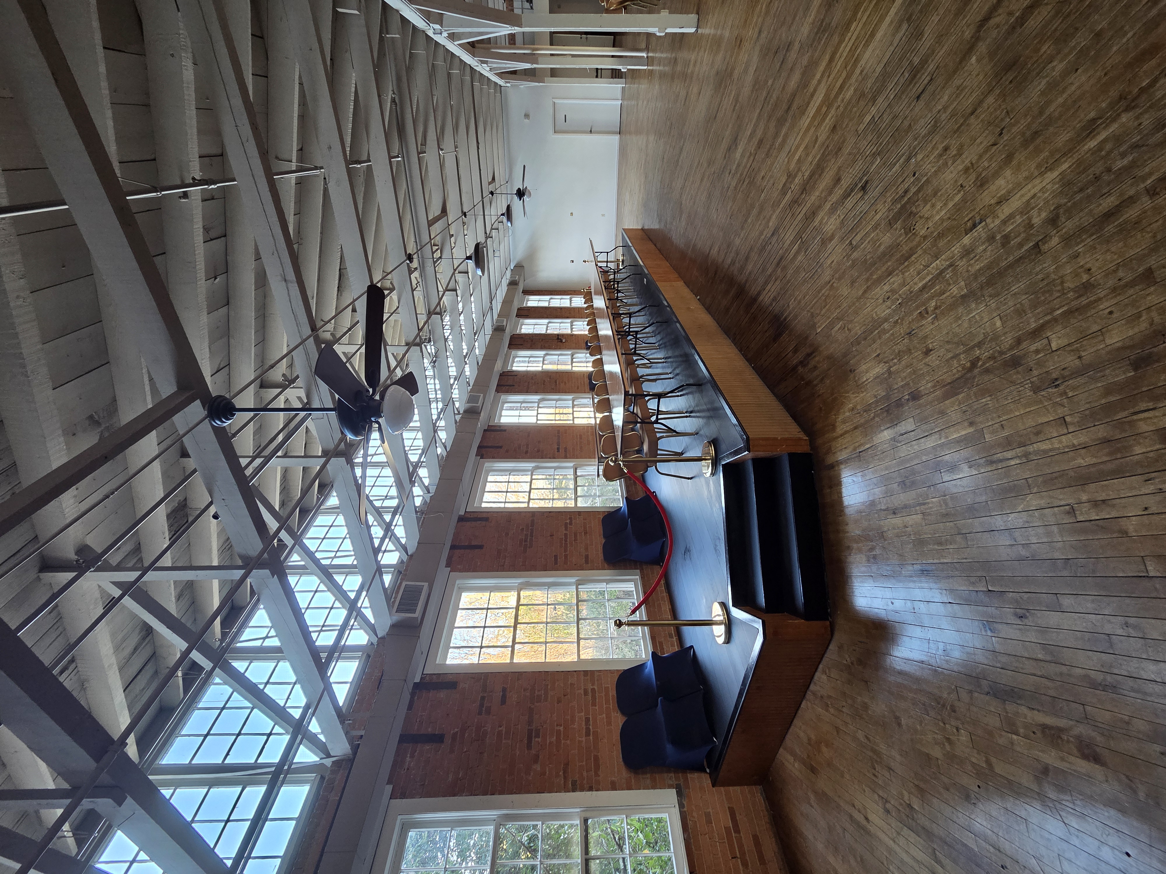 The Mill & Market interior with stage, exposed brick, and tall windows
