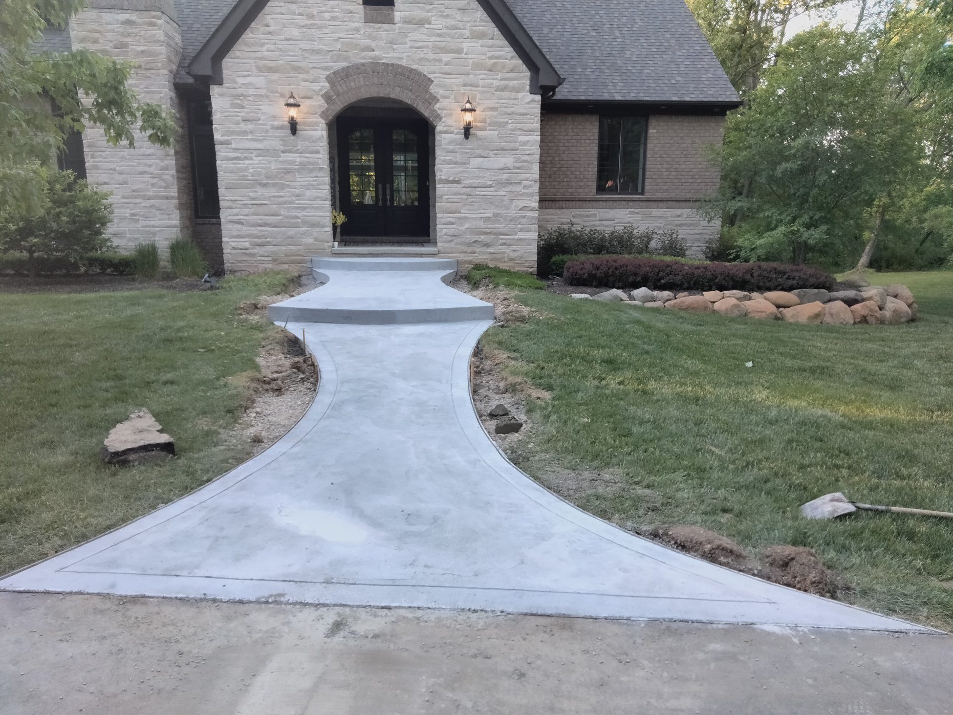 Curved Concrete Walkway — Luxury Home Entry