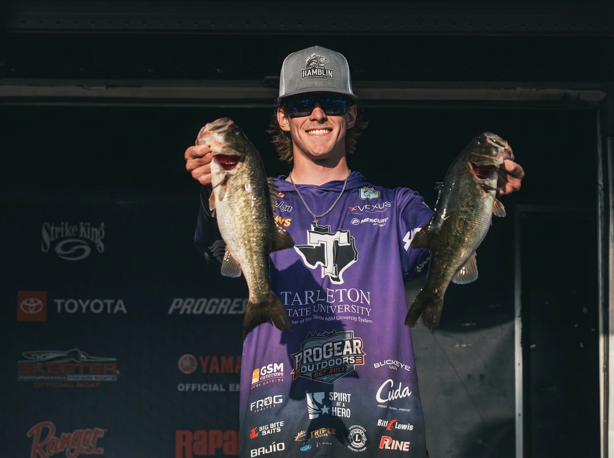 Aiden at the weigh-in stage holding two bass