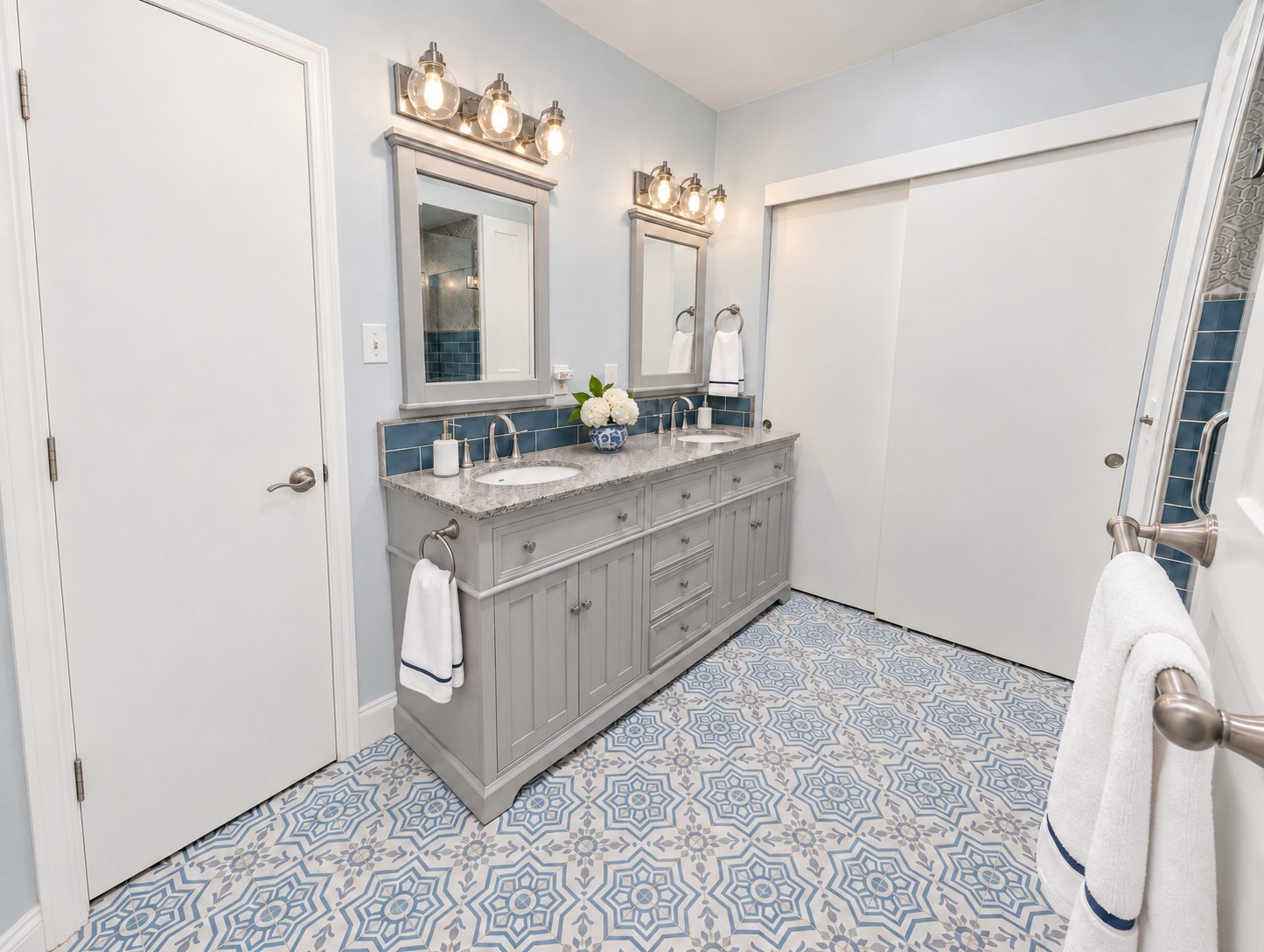 Updated bathroom with double vanity and patterned tile floor